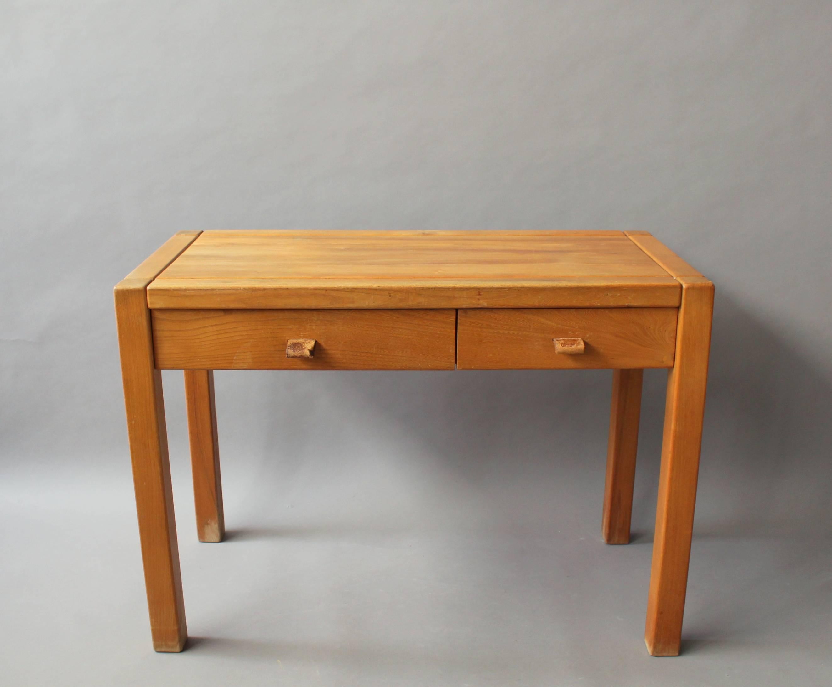 French 1950s two drawers oak desk with leather pulls in the manner of Pierre Chapo.
