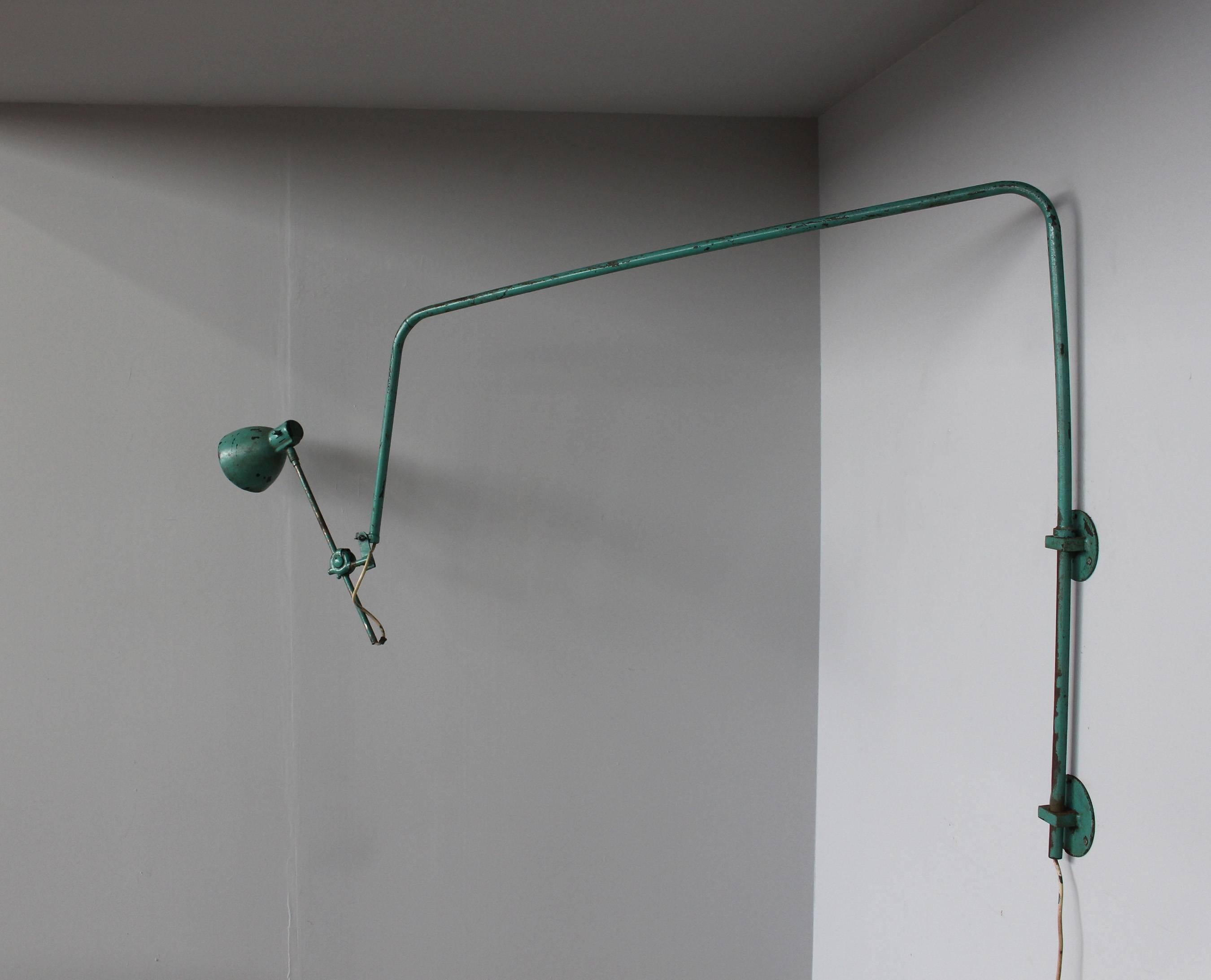 A French adjustable Industrial green lacquered metal wall light.

