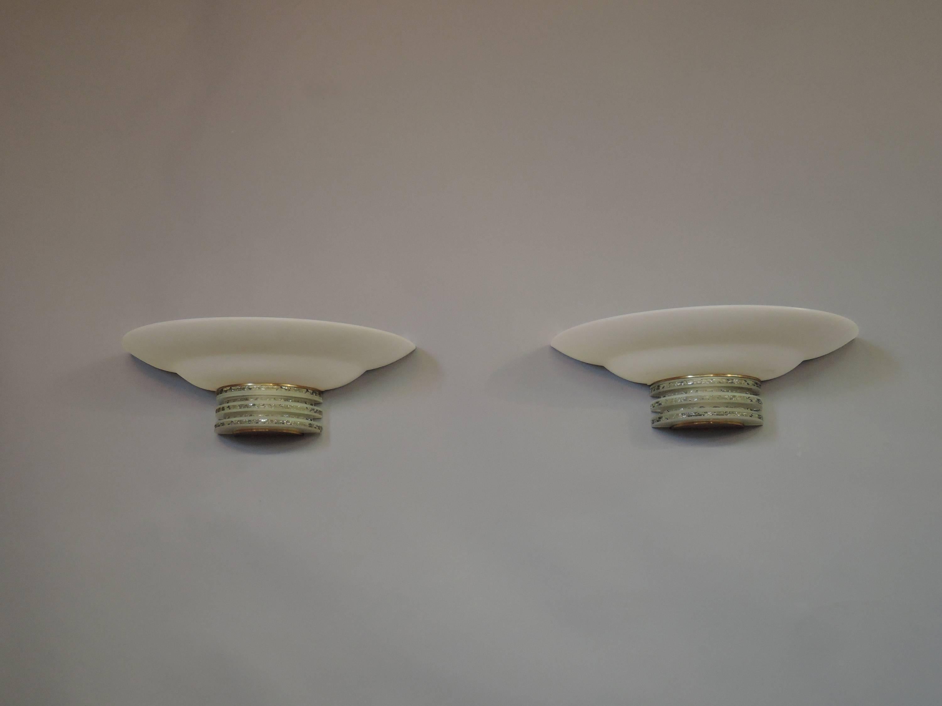 Pair of fine French Art Deco ground glass slabs and brass wall sconces by Jean Perzel with thick white glass shades.