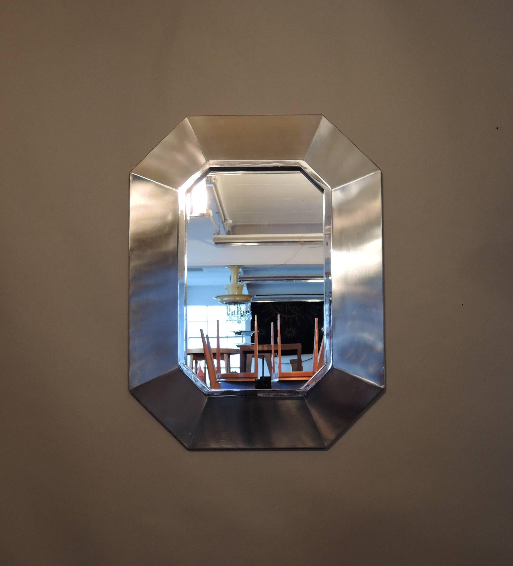 Fine French Mid-Century mirror with an octagonal stainless steel frame attributed to Jansen.
