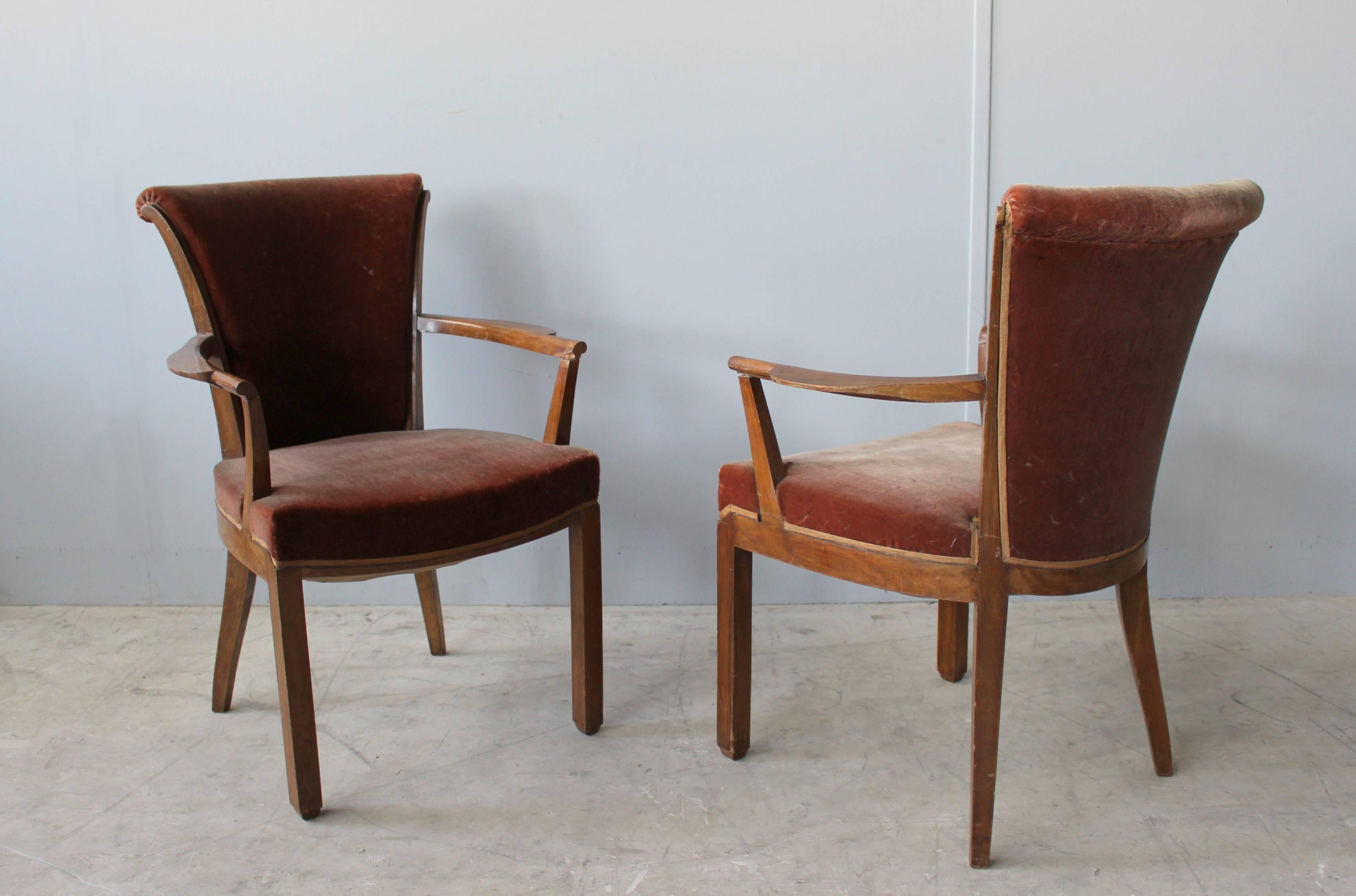 A set of nine fine French Art Deco walnut side chairs and two matching armchairs by Leleu. 
This set of chairs is part of an emblematic dining set designed by Jules Leleu for Mr. Renaud in 1929, including a dining table and a sideboard (also