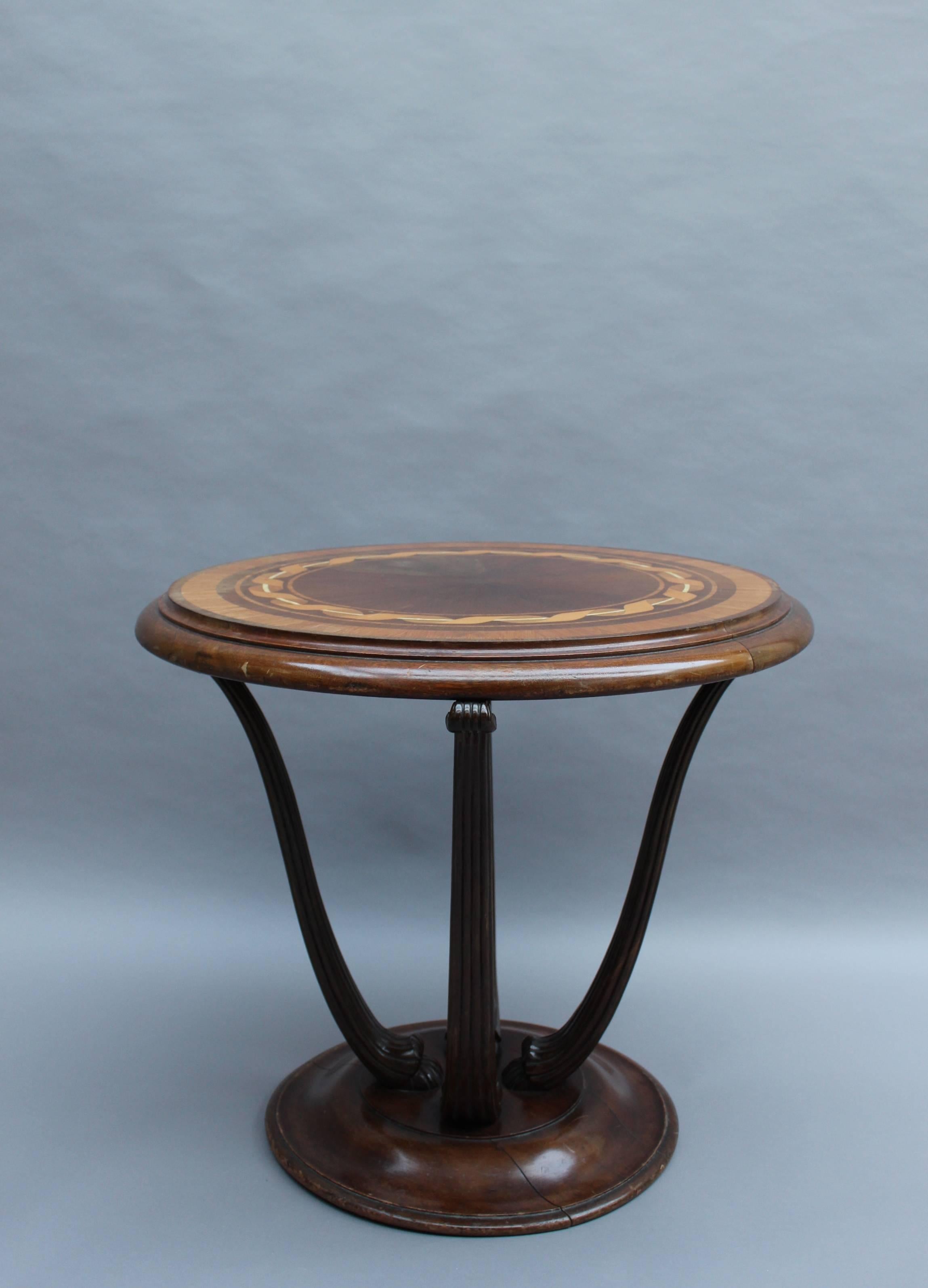 Fine French Art Deco gueridon or center table with four fluted legs and a marquetry top by Atelier Ernest Schmitt.
