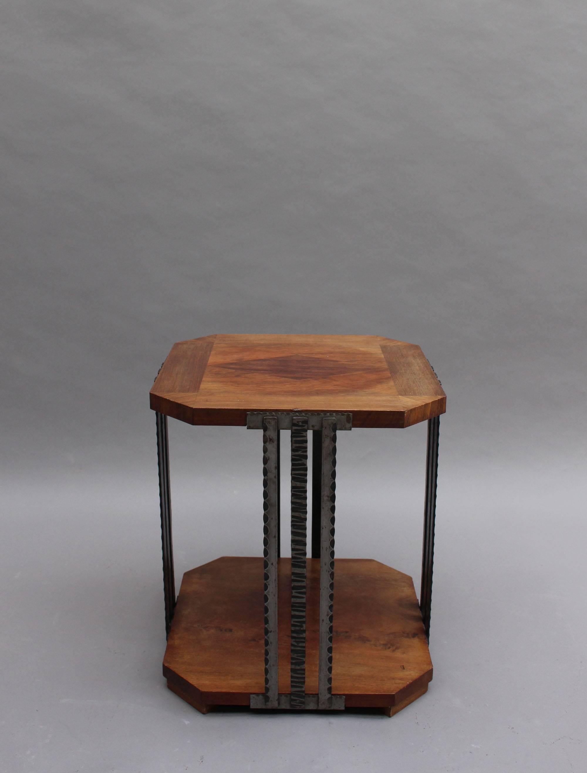 A fine French Art Deco two-tiered gueridon or side table with four triple wrought iron stems legs that support a walnut marquetry top.