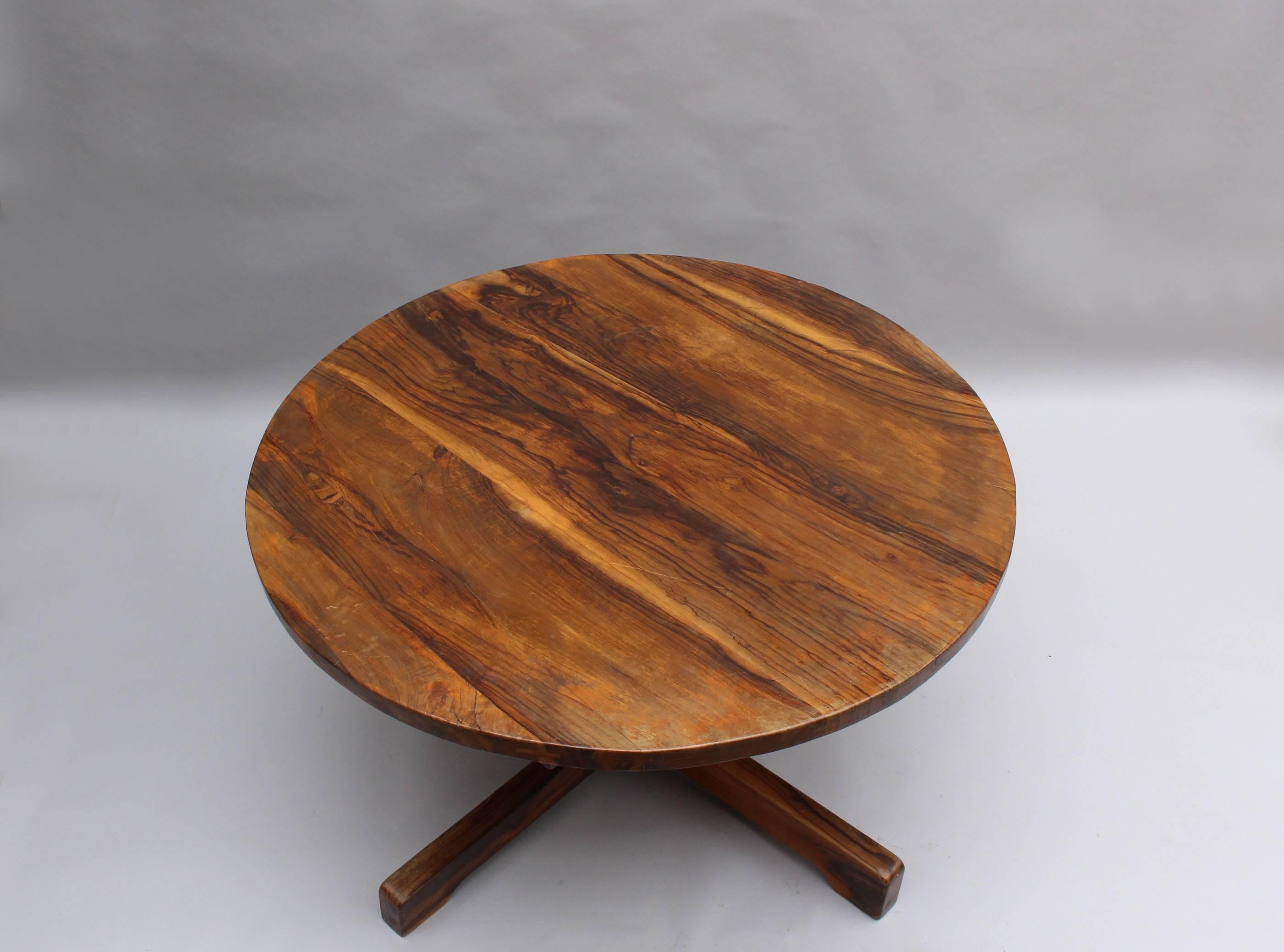 A French Mid-Century solid olive tree dining / center table with a square pedestal and a round top.