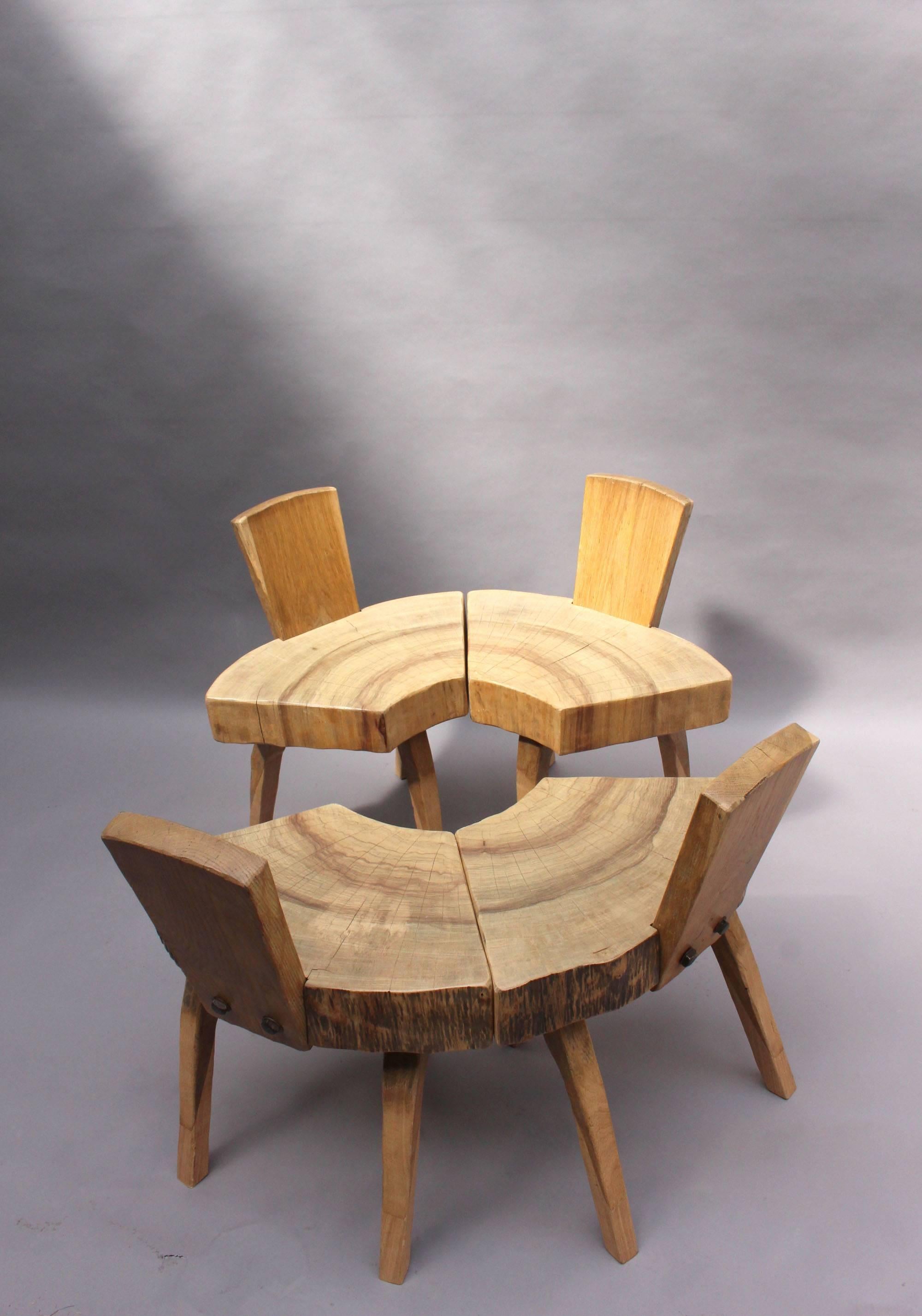 Four Mid-Century organic oak chairs with a tree trunk slice seat on three legs and metal details.

Price is per chair.