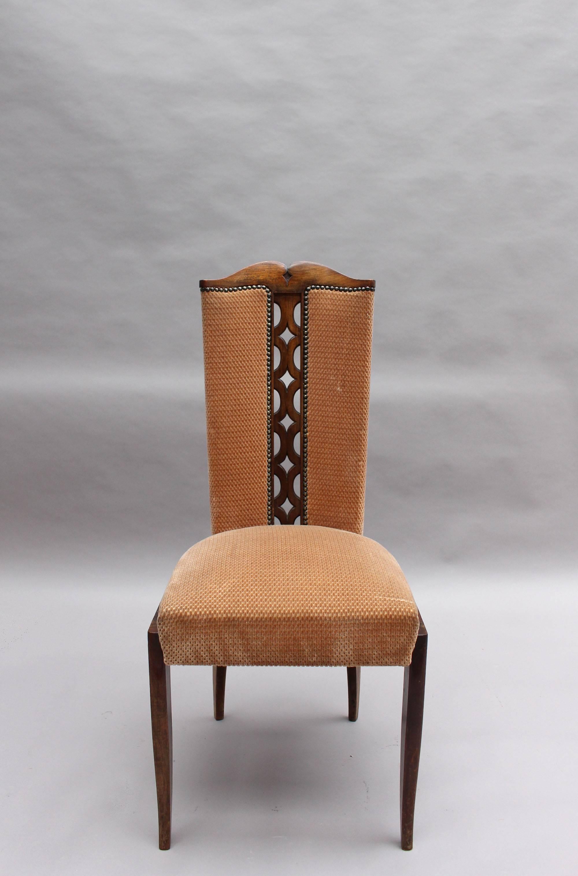 A set of eight fine French Art Deco dining chairs with wooden tracery on the center back.