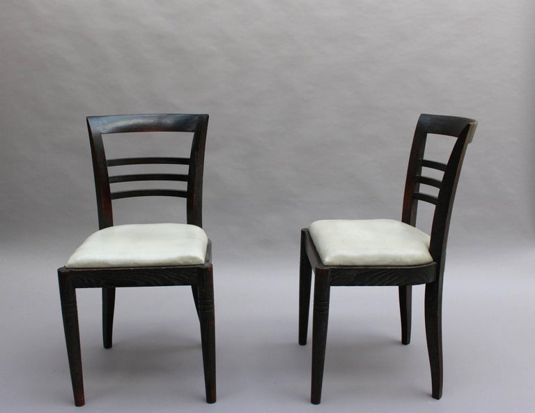 Set of eight fine French Art Deco ebonized oak dining chairs with a light ceruse.