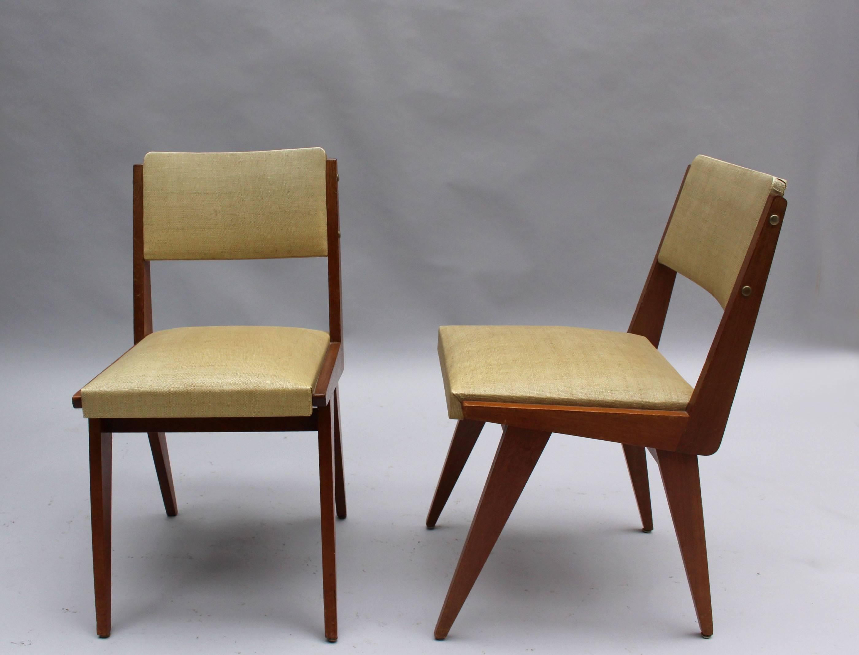 Set of six French mid-century dining chairs with compass-style legs.