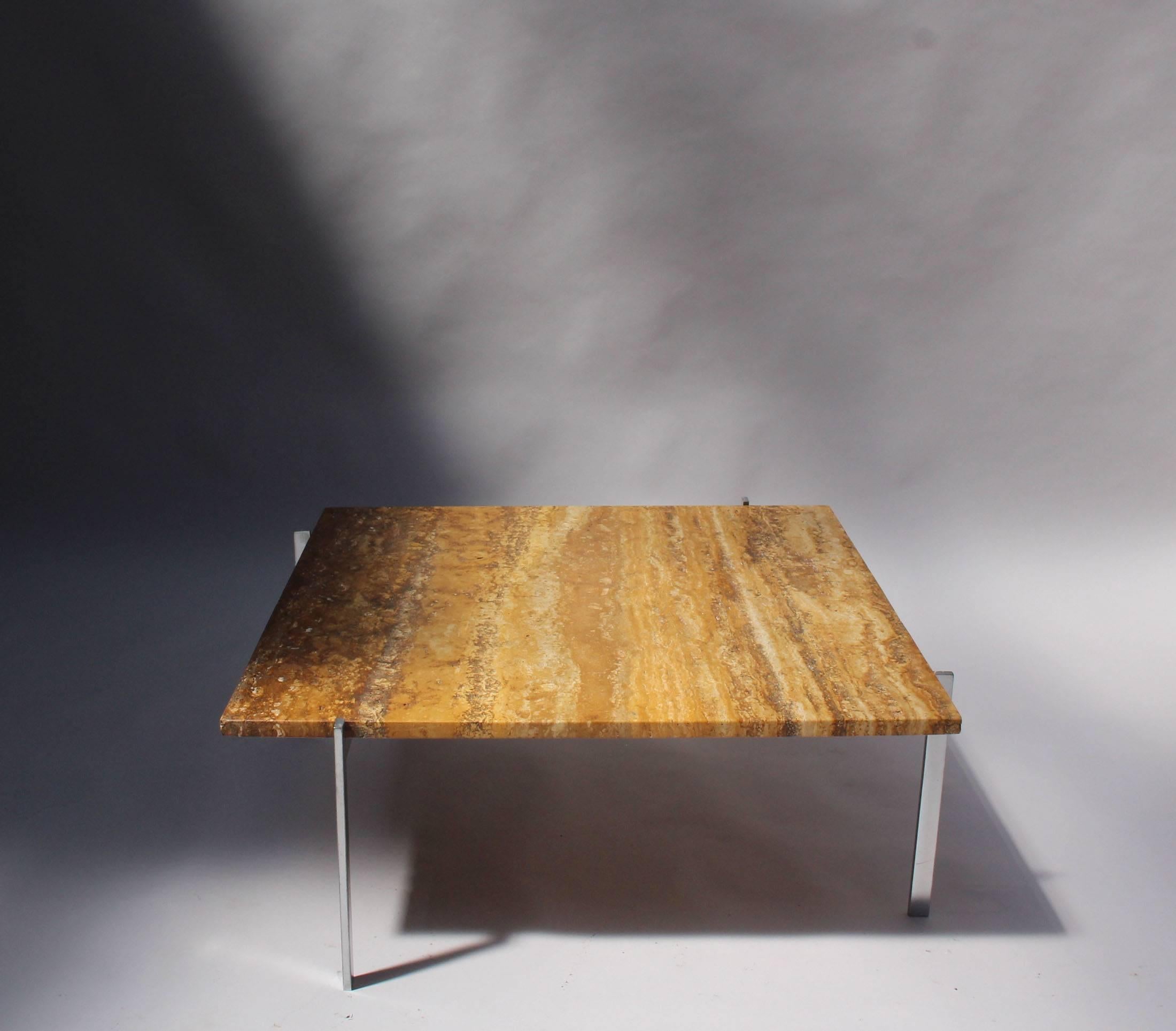 With a travertine top on a chromium-plated steel base.