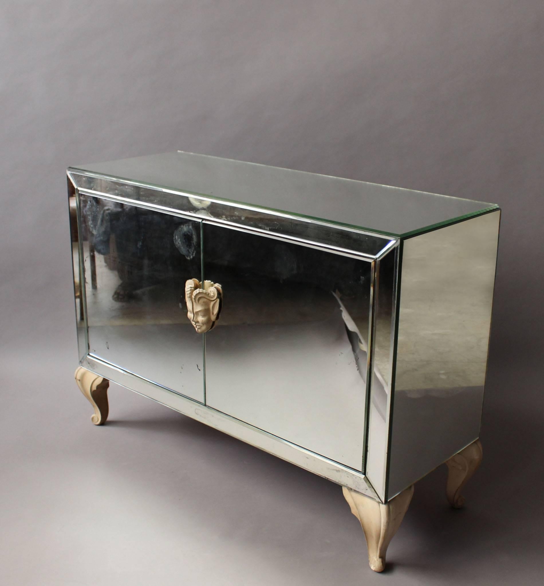 A Fine French Art Deco mirrored buffet / commode with refine hand painted carved wooden faun head pulls and curved legs.