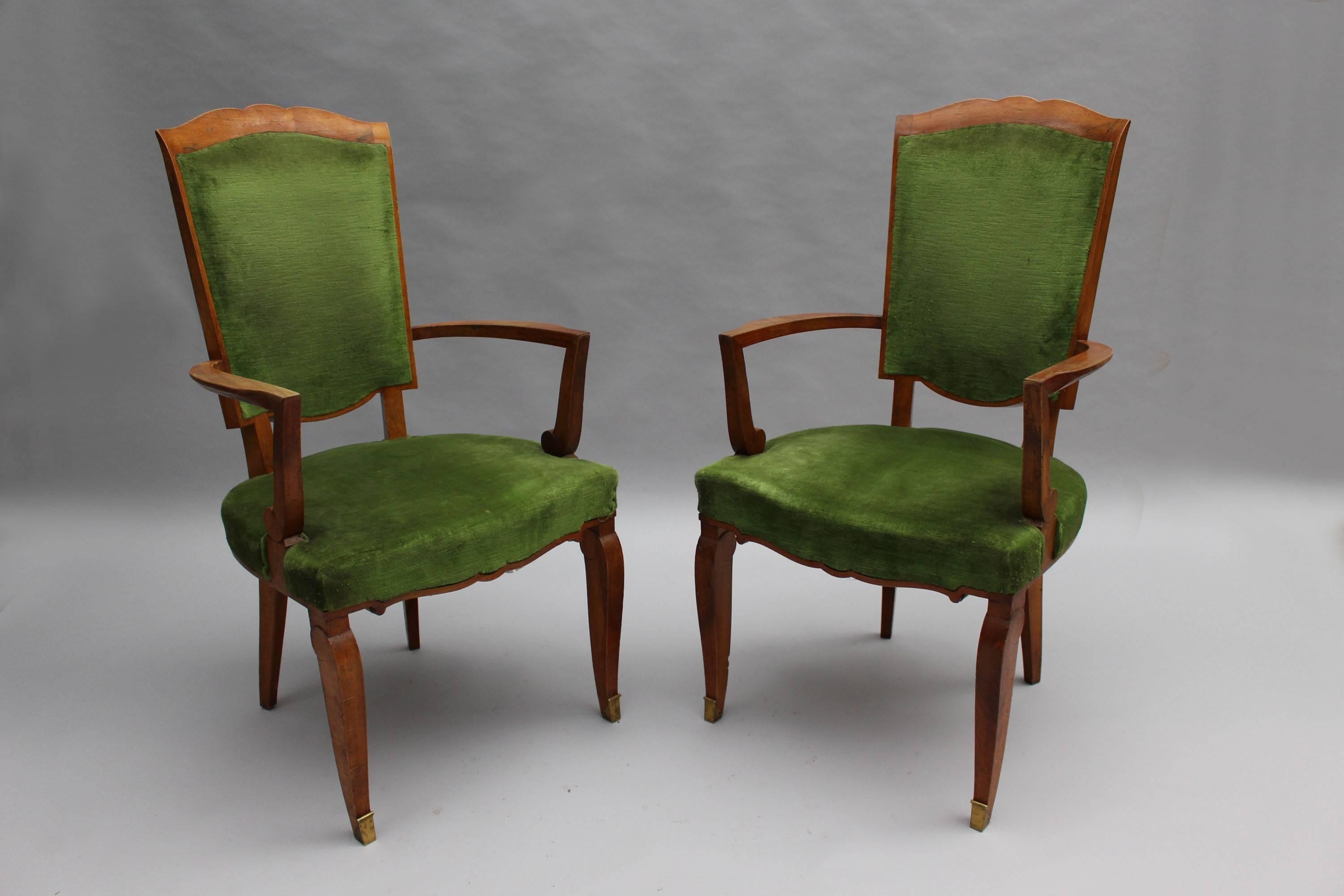 A set of ten fine French Art Deco dining chairs (eight side and two arm), in walnut with bronze sabots. 
Design by Jules Leleu for the Palais de l'Elysee in 1947

Documentation:  Similar chairs represented in the book  