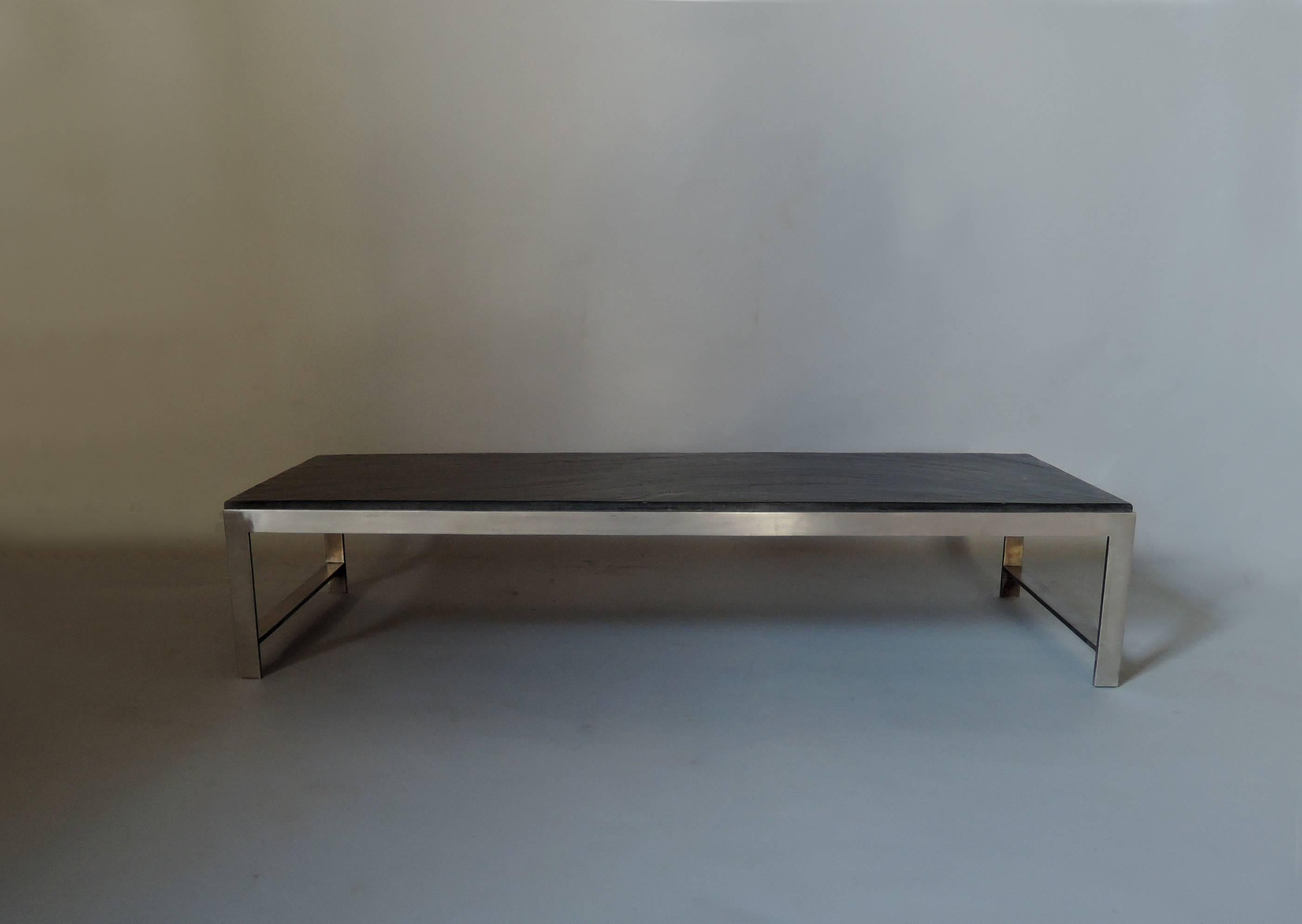 A large fine French 1970's stainless steel base coffee table with a dark slate top.
 