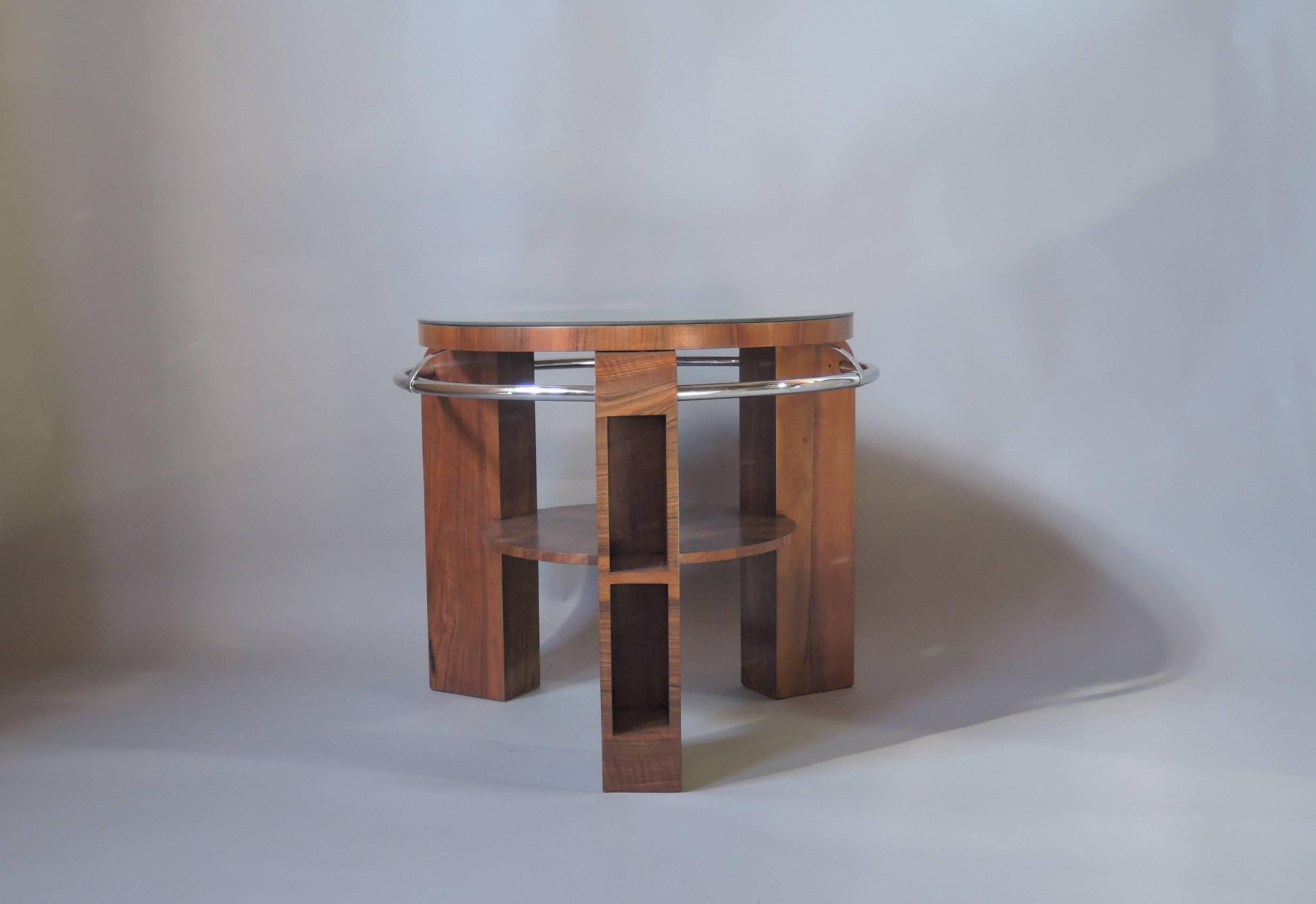 A fine French Art Deco two-tiered walnut gueridon supported by three legs with niches linked by a chromed circular tube. Beveled mirrored top (27 1/5