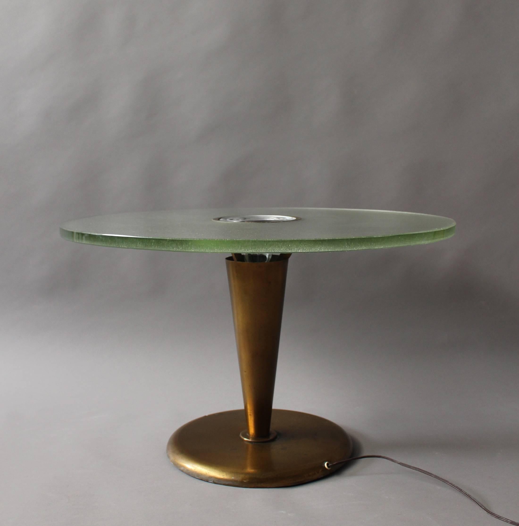 Fine French Art Deco illuminated gueridon/center table made with a conical metal base supporting a Saint Gobain glass slab top with a center prismatic glass lens by Jean Perzel.