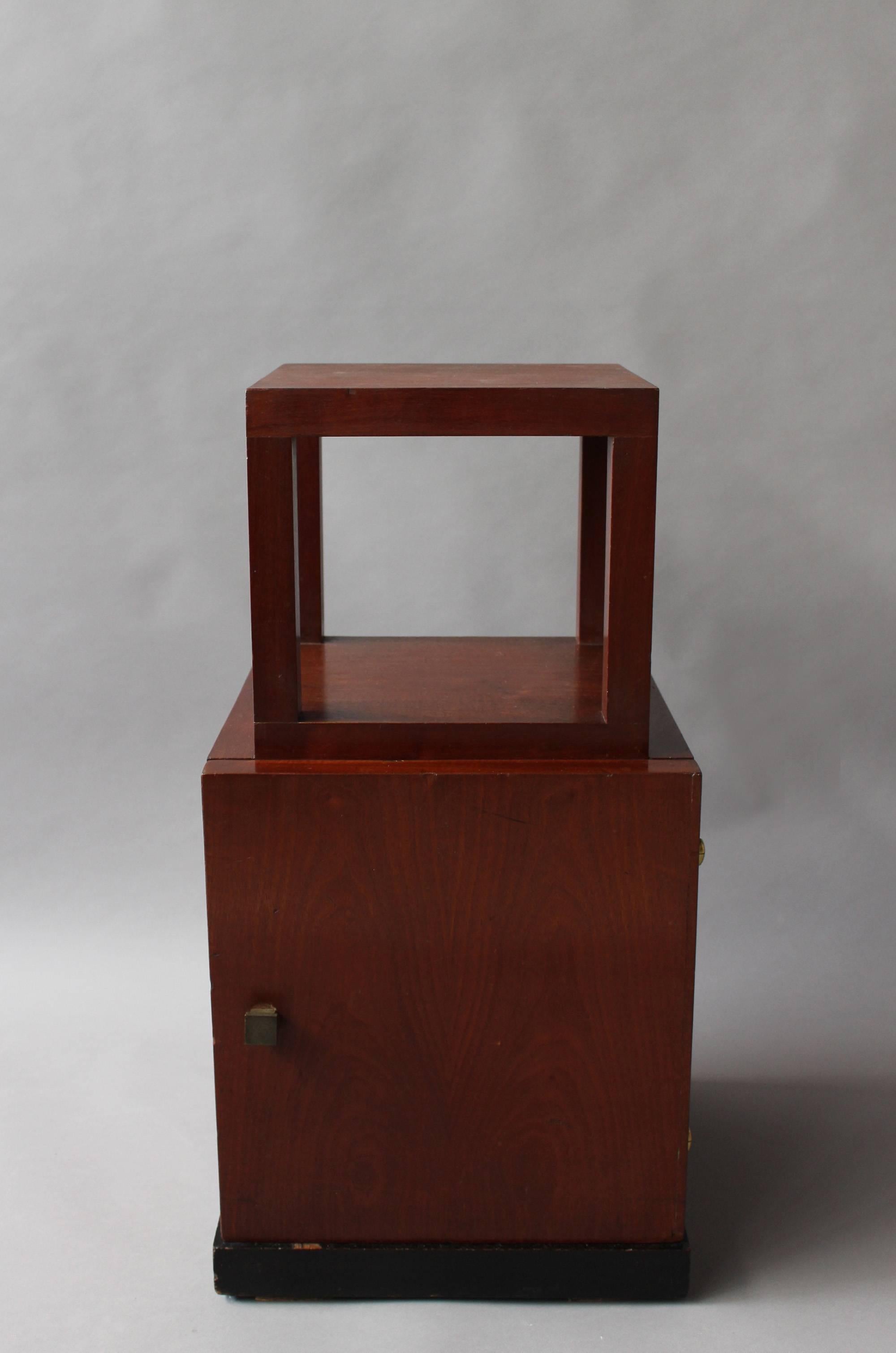 French Art Deco two-tier mahogany side table/nightstand with a pull out shelf and brass details.
     