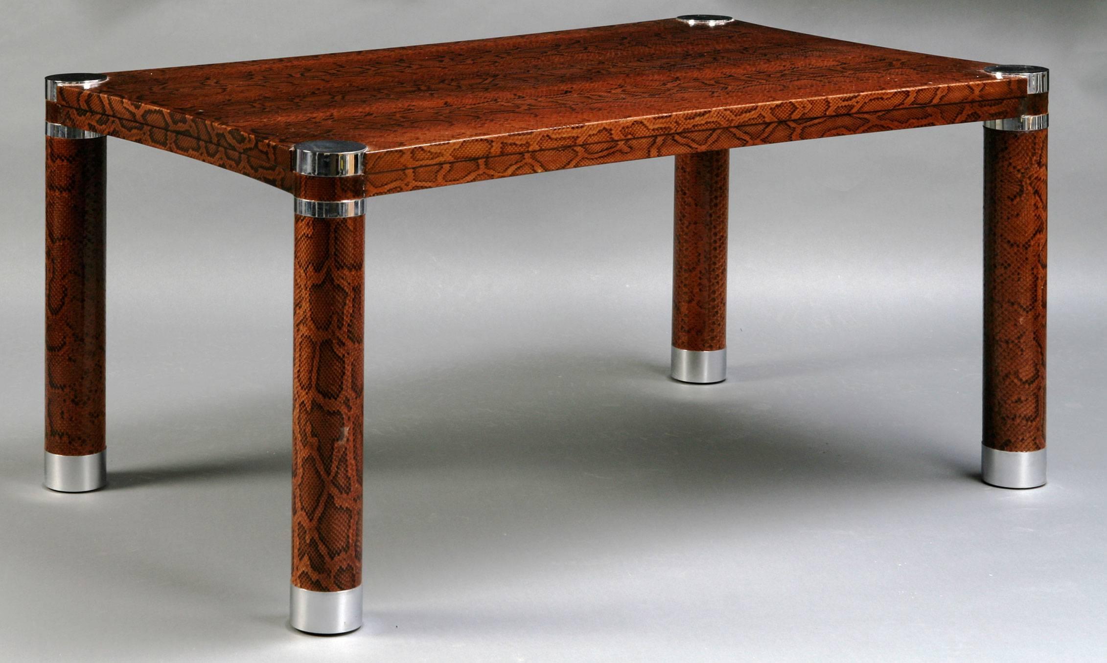 Rectangular coffee table covered in real brown python with polished steel banding on the legs.