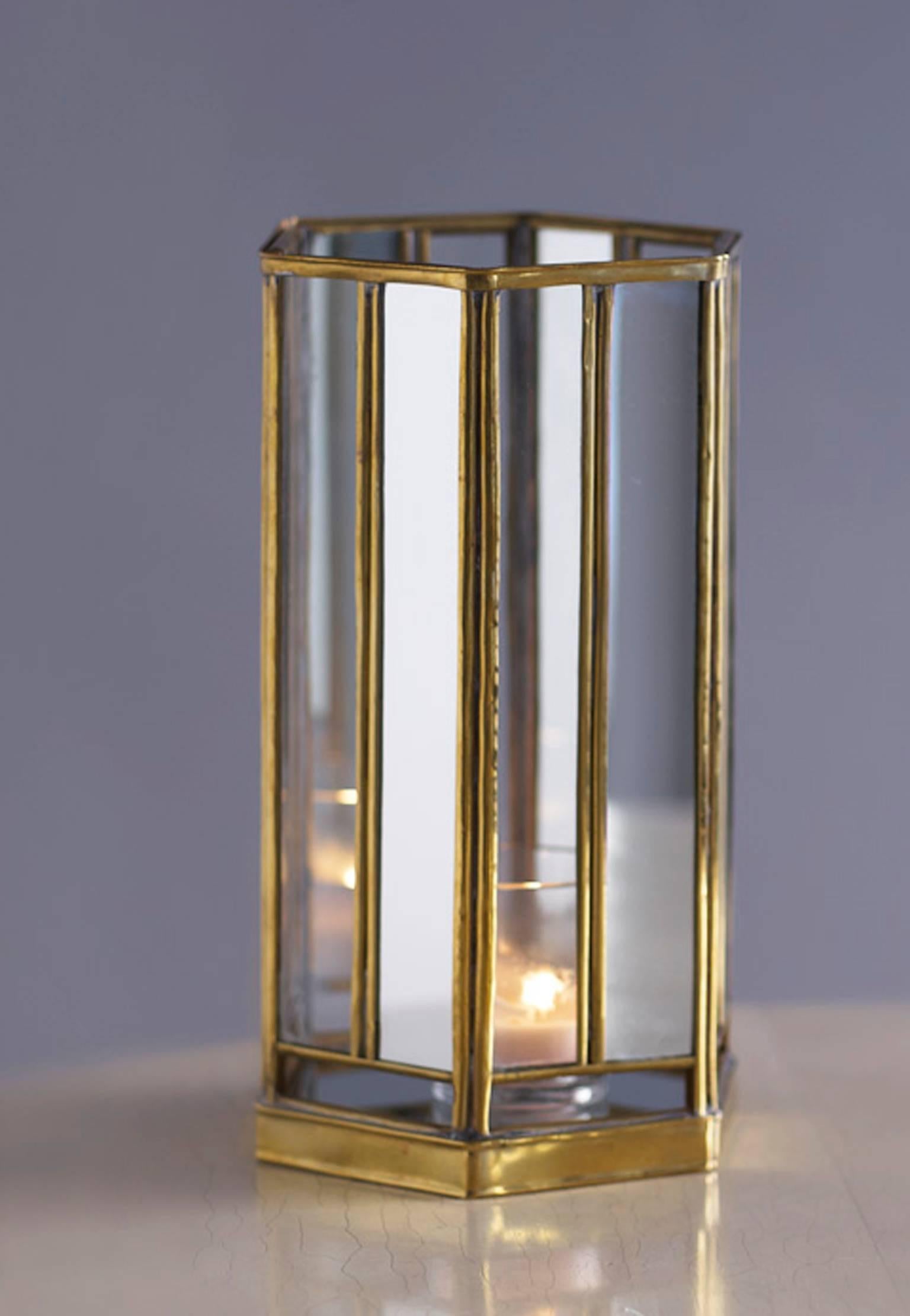 Hexagonal hurricane light with alternating panes of antiqued mirror and clear glass set in brass trim. Illuminated with a votive candle. 
Originally designed by Albert Hadley for the Pisces Club in Georgetown in the 1960s.
Made expressly for Liz