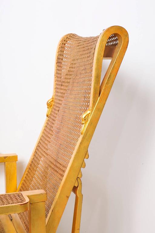 André Arbus, (1903-1969).

Giltwood armchair with adjustable back, turned stretchers, and caning on the seat, back and arms. The rounded back terminates in a carved swan head on either side,
French, circa 1945

Beautifully illustrated in