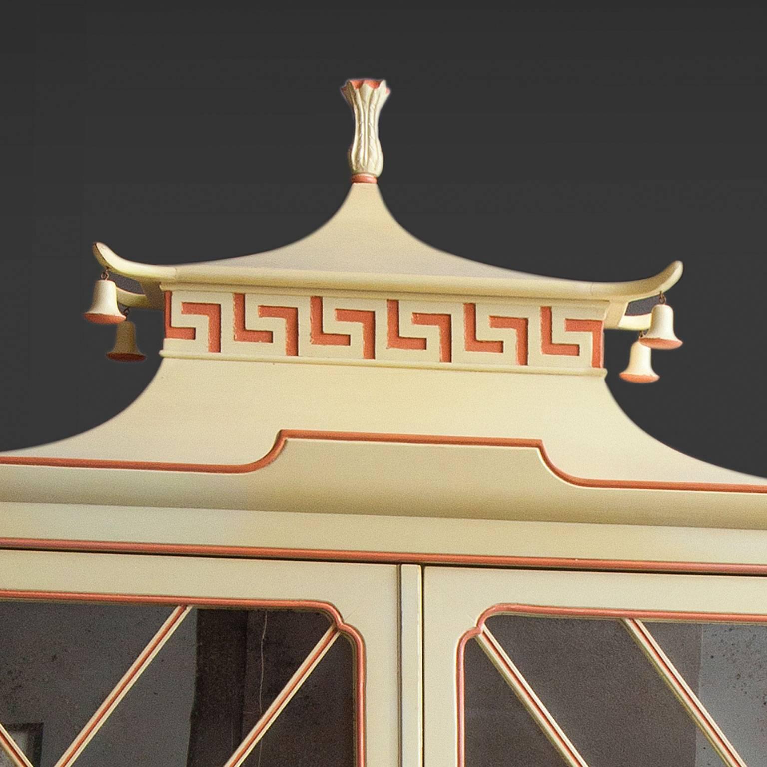 Pair of lacquered chinoiserie cabinets. 
The cabinets have two antique mirror doors with fretwork 
opening to reveal mirrored interiors with one shelf. 
The brass door pulls in bronze in the form of jumping carps.
Executed by Tomlinson