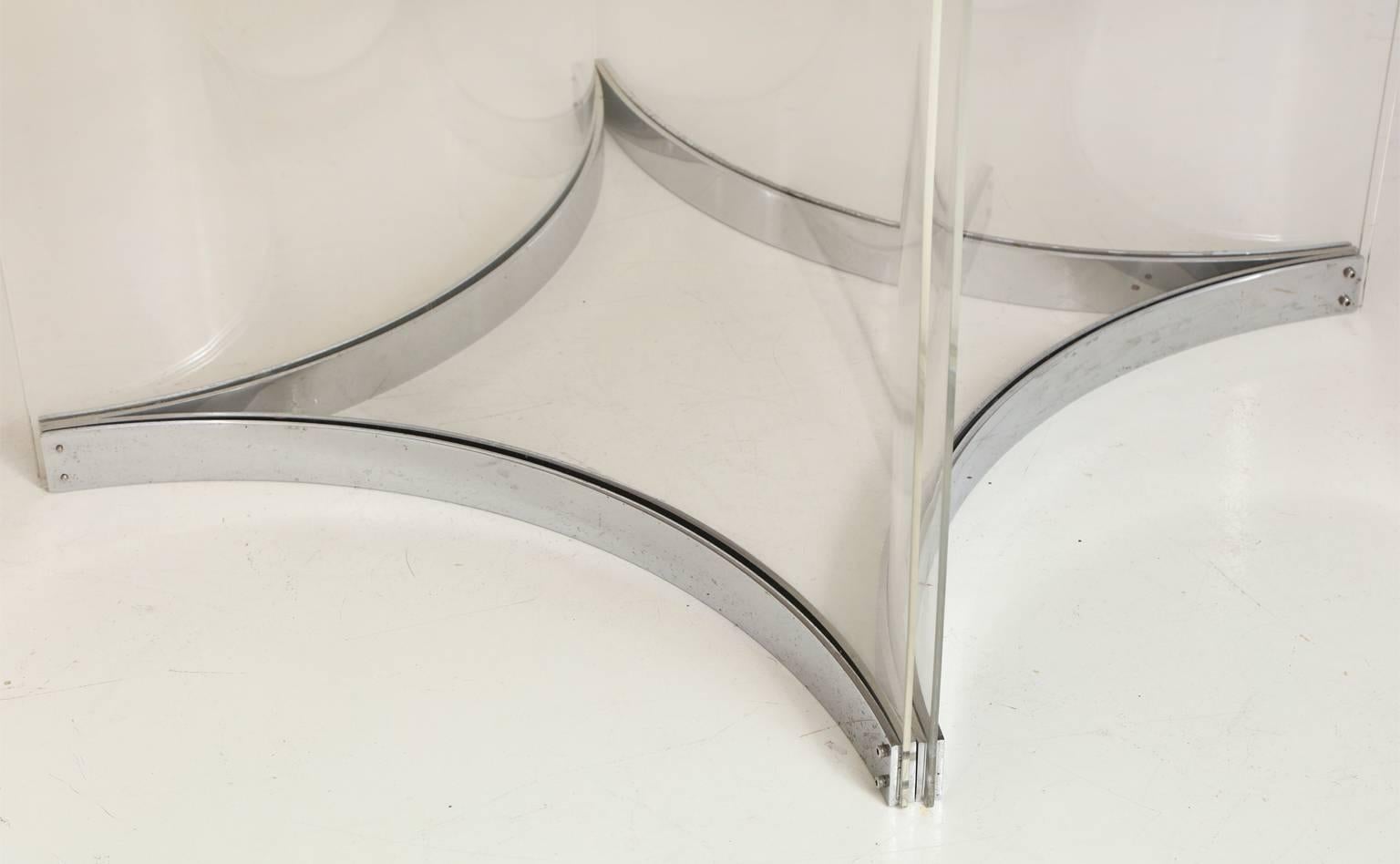Alessandro Albrizzi (1934-1994).
Smoked-glass top round dining table with base in clear perspex and chromed steel trim. Four panels of hand-curved plexiglass sandwiched at top and bottom in a polished silver metal frame.  Albrizzi was a darling of