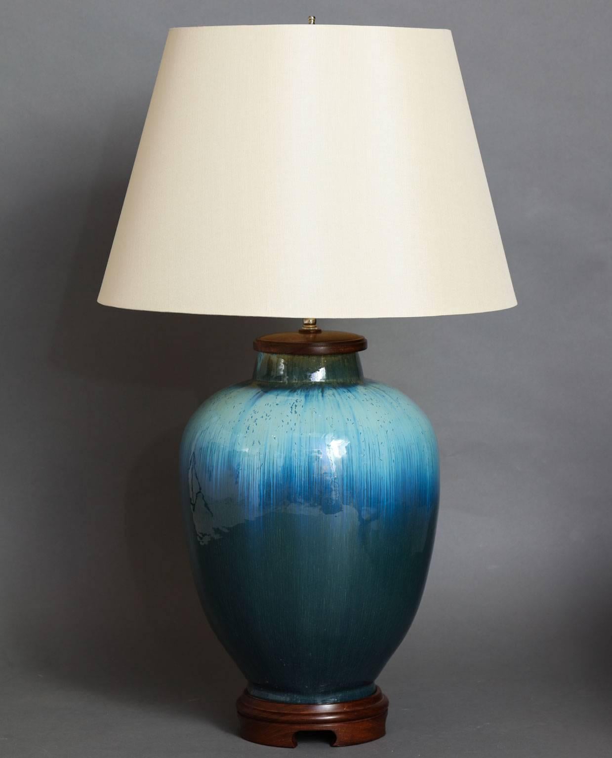 Water jar table lamp.
Hand-formed ceramic lamp base available in many beautiful glazes,
with optional wood bases available in two heights and a variety of wood finishes. Wired with two-bulb cluster in either antique brass or polished nickel, with