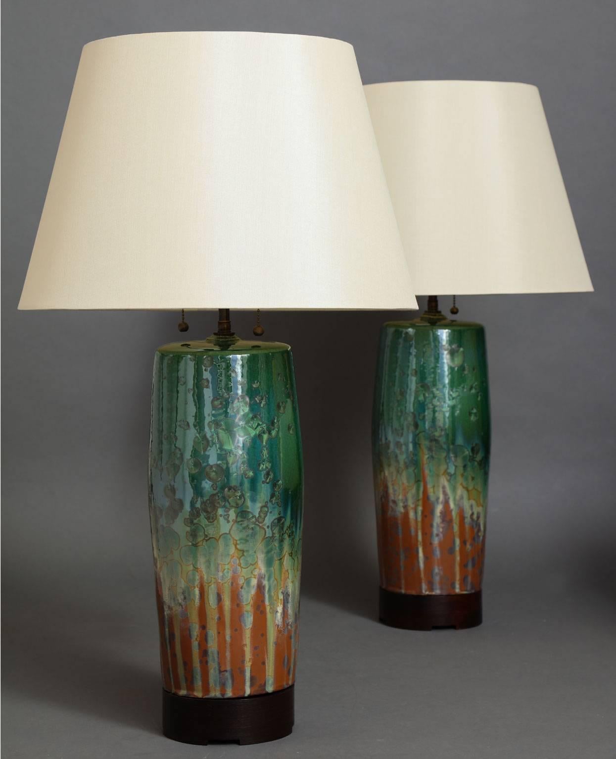 Bulldog table lamp.
Pair of hand-formed ceramic lamp base available in many beautiful glazes, 
with optional wood bases available in two heights and a variety of wood finishes. Wired with two-bulb cluster in either antique brass or polished