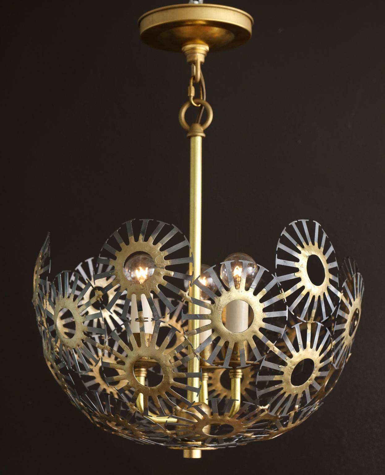 Marie Suri the Piera pendant light.
Hanging three-light chandelier composed of 4