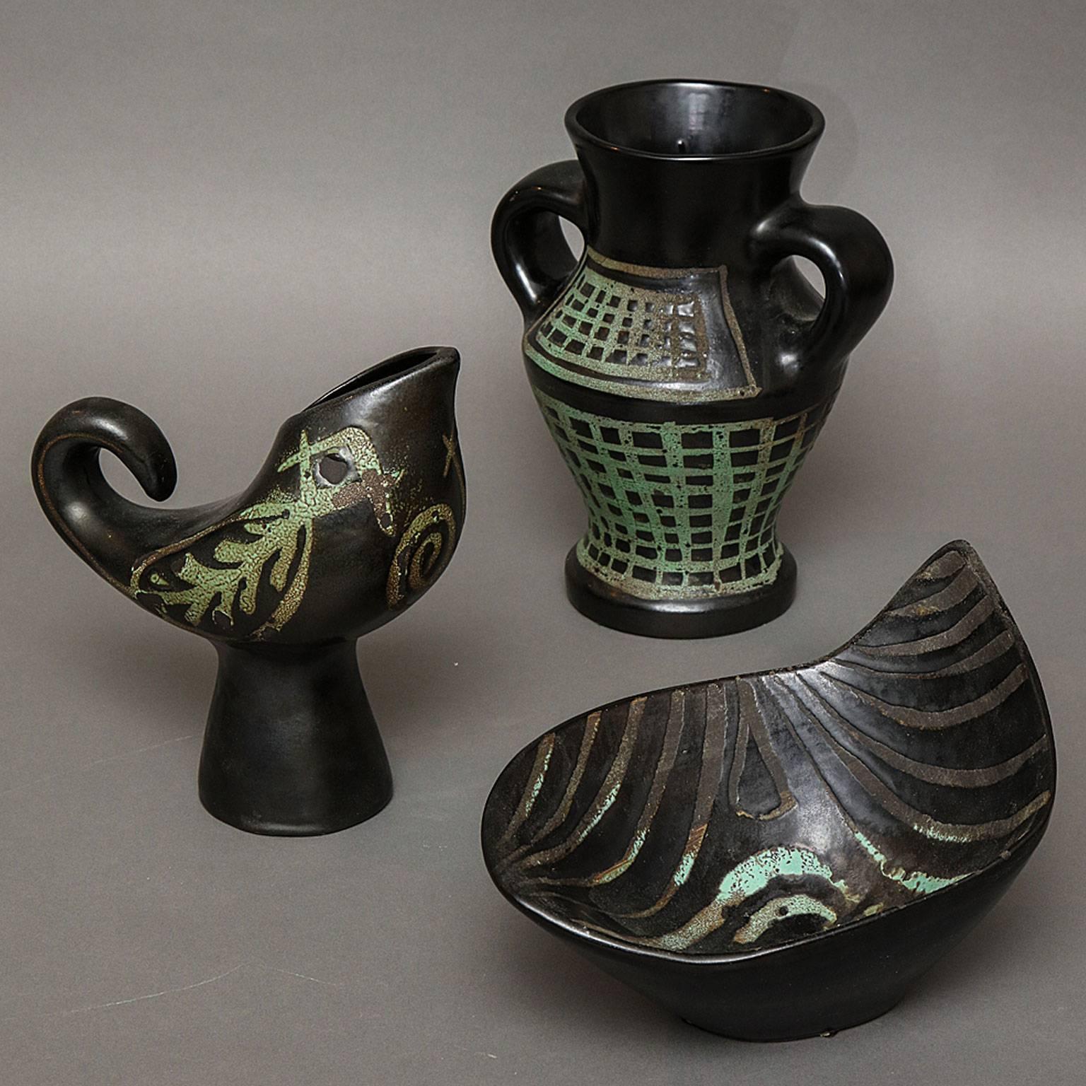Roger Capron (1922-2006)
A trio of ceramic vessels with matte glazes on black faience.
Included are the coupe, the zoomorphic Vase Coq, and the Classical Vase à Anses. 
Jug Signed: CAPRON, coupe and bird signed: Capron Vallauris France
French,