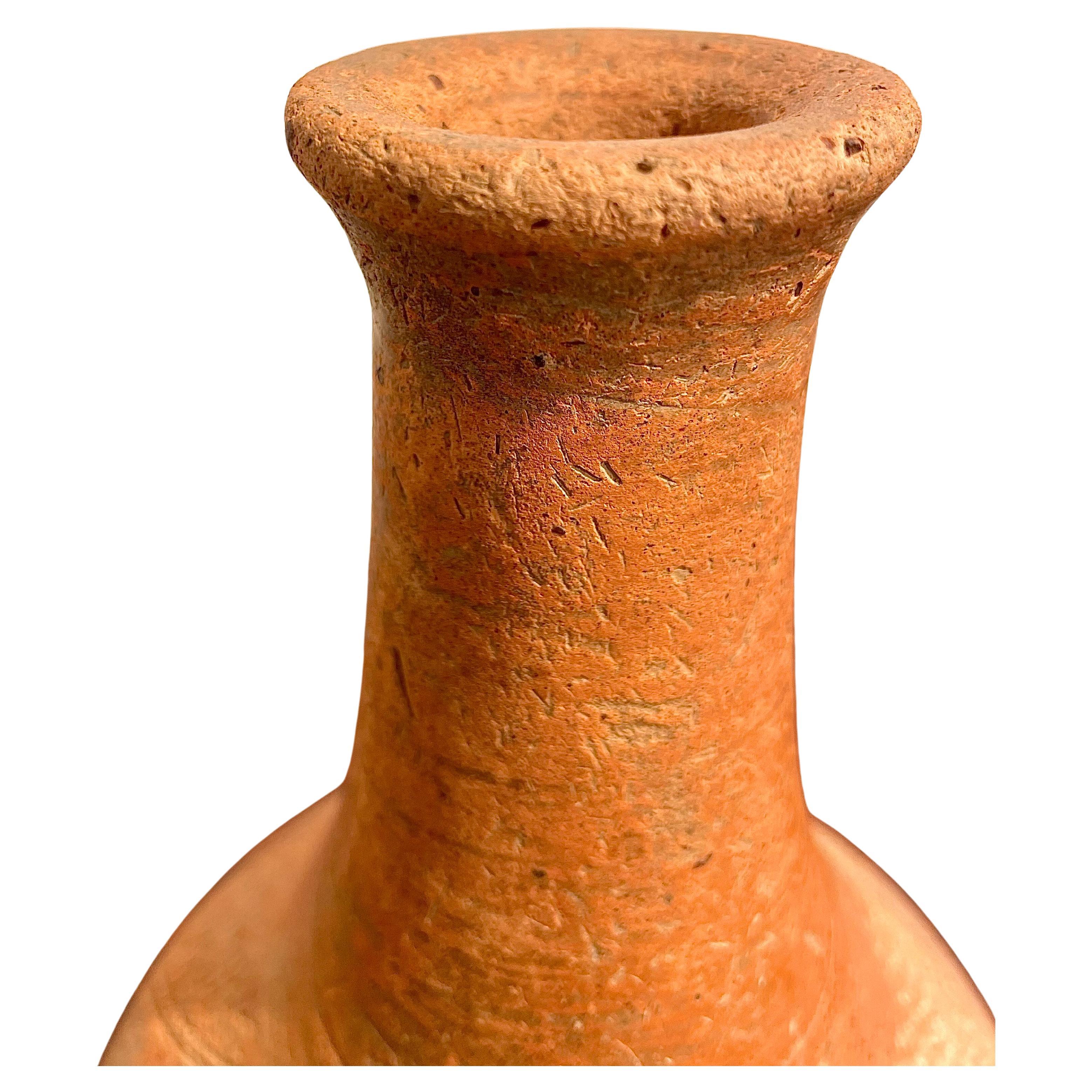 Possibly 15th-17th centuries, excavated from Niger (Africa), beautiful red clay slip with incised bands, high neck ending in a flared lip, fine example. 
Beautiful decorative and ethnic object.
Tomb object from an ancient site. 
