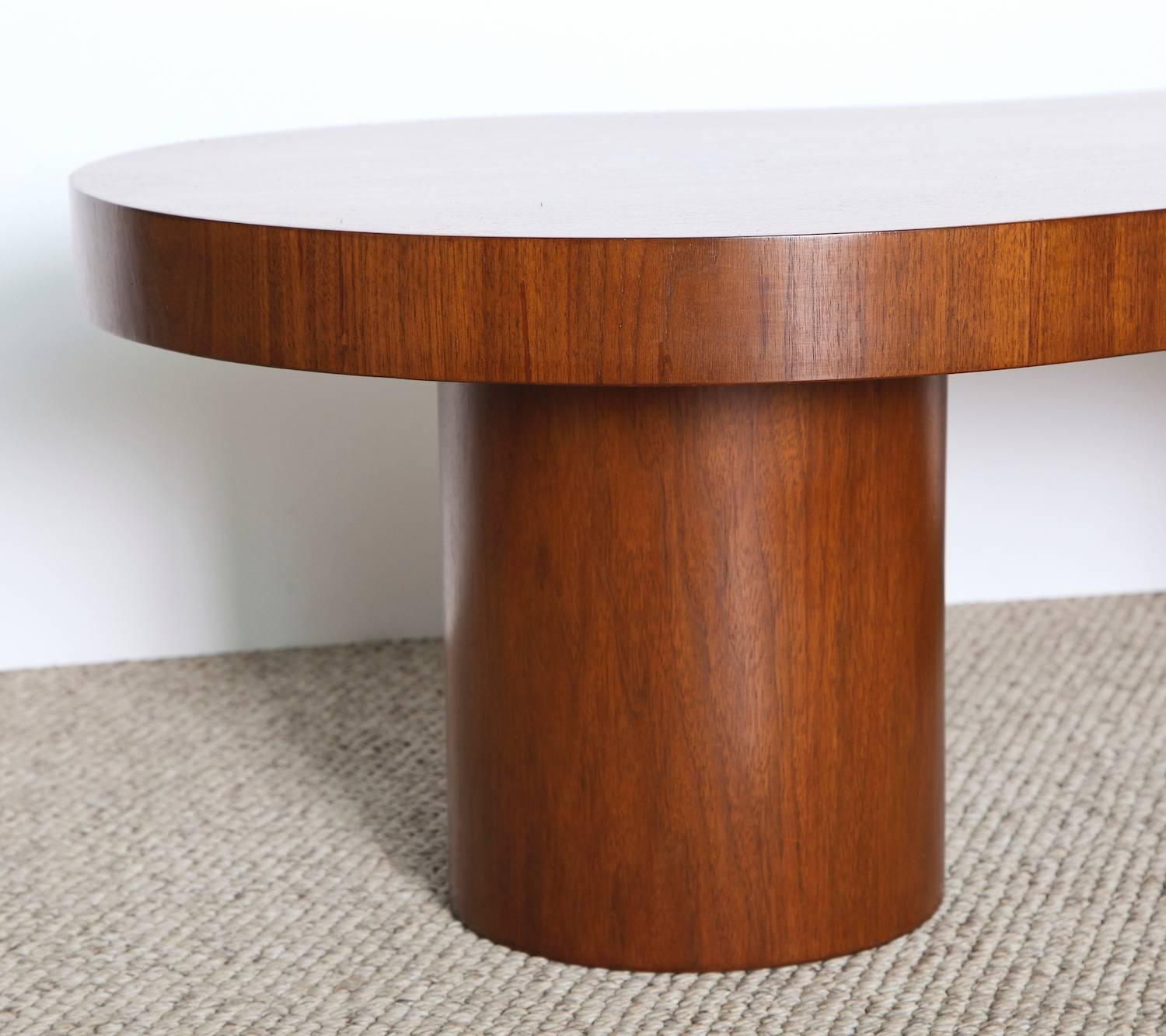 Studio-built cocktail table of walnut with two large-scale cylinder bases. This piece was custom-made for a private commission and bears the Laszlo Studio metal label on the underside of the top. An great example of Laszlo’s post war work, and an