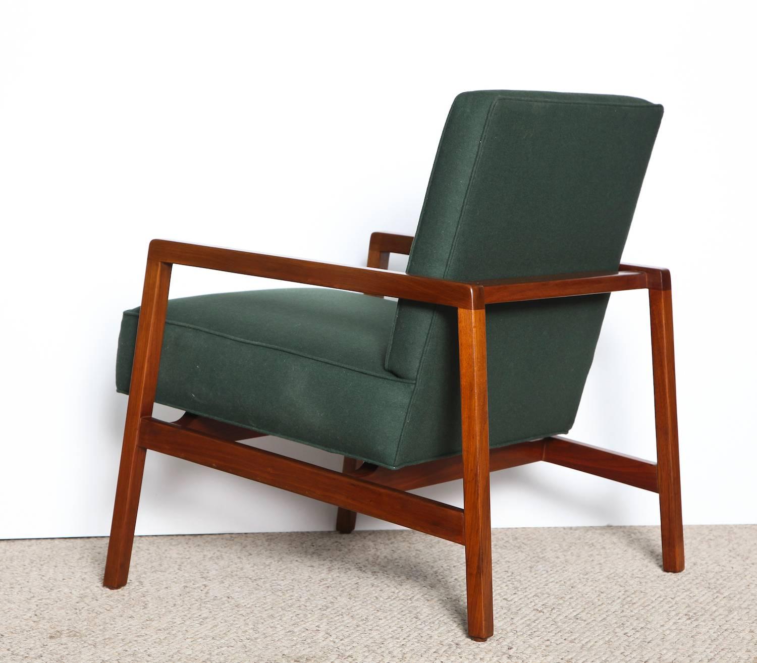 Beautiful and tailored lounge chairs with solid teak frames, and hunter green wool/felt upholstery. Recently fully restored.