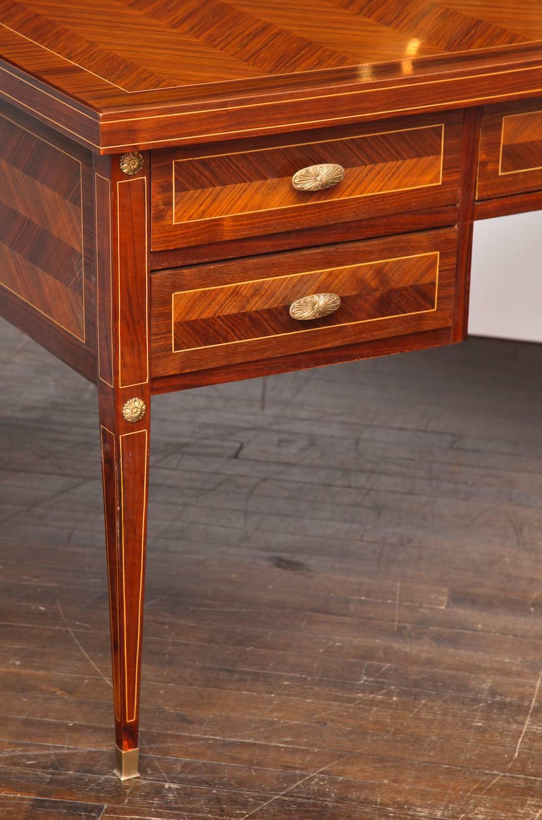 Five-drawer desk by Paolo Buffa. Fantastic desk of figured rosewood veneer, bookmatched in a chevron pattern with light wood inlay trim details. Five drawers with cast brass pull handles and brass sabotz. An extraordinary example of the cabinetry