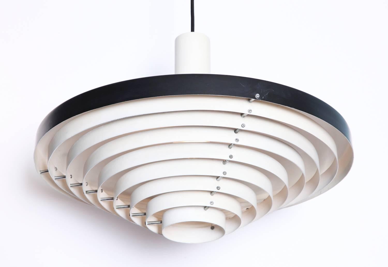 Rare pendant light by Stilnovo. Circular hanging light, with slatted detailing. Black and white lacquered aluminum and chromed metal spacers. Original Stilnovo label on top. A rare from in excellent condition.
