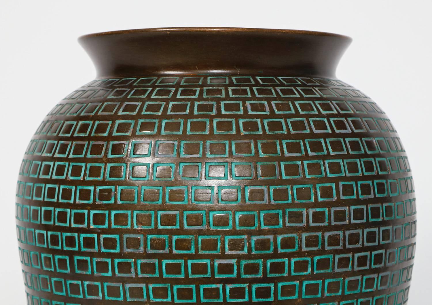 Large earthenware form glazed in bronze-brown with incised rectangle pattern outlined in blue glaze. Signed in underside.