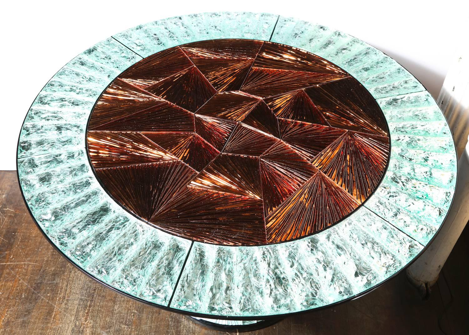 Unique center table by Donzella & Ghiró Studio. Circular pedestal table of black lacquered wood support with inset, hand-carved and chiseled glass elements throughout. An incredible example of the craftsmanship of Ghiró Studio and their