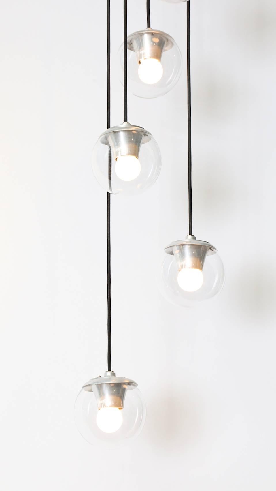 Gino Sarfatti for Arteluce five-light hanging fixture #2095. Cascading light with five glass globes hanging at different heights. Each orb contains 1 Edison sized socket. A beautiful and rare Sarfatti design.