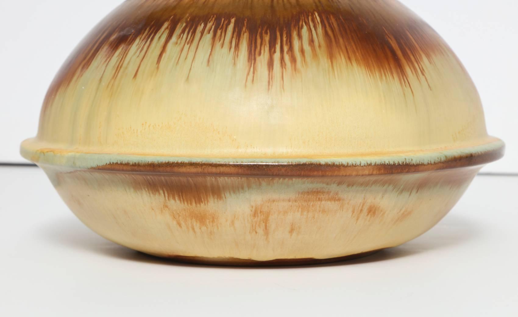 Jana Merlo studio-made earthenware vase. Great wide-body bottle form with relief waist and spout opening at top. Glazed in tans and rust colors. Signed on underside.