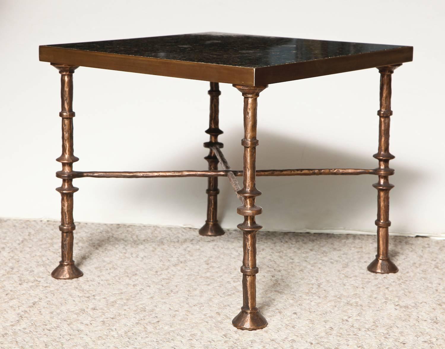 Beautiful low drinks tables of bronze with stone tops. Hand-forged bronze bases, hammered texture with custom patina. These tables are priced per table, are made per order in France and require a 12-15 week lead-time.