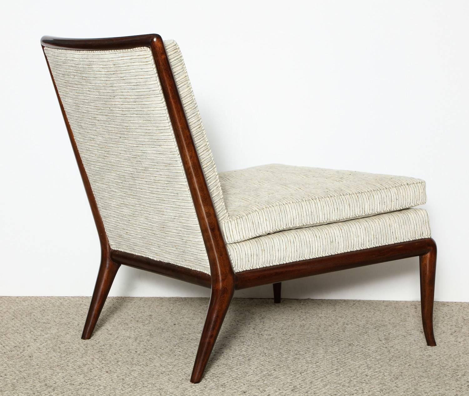 T.H. Robsjohn-Gibbings designed WMB slipper chair for Widdicomb.  Elegant form of dark stained wood and pale colored upholstery. A Robsjohn-Gibbings Classic design, with tapered legs and bull-nose framing.