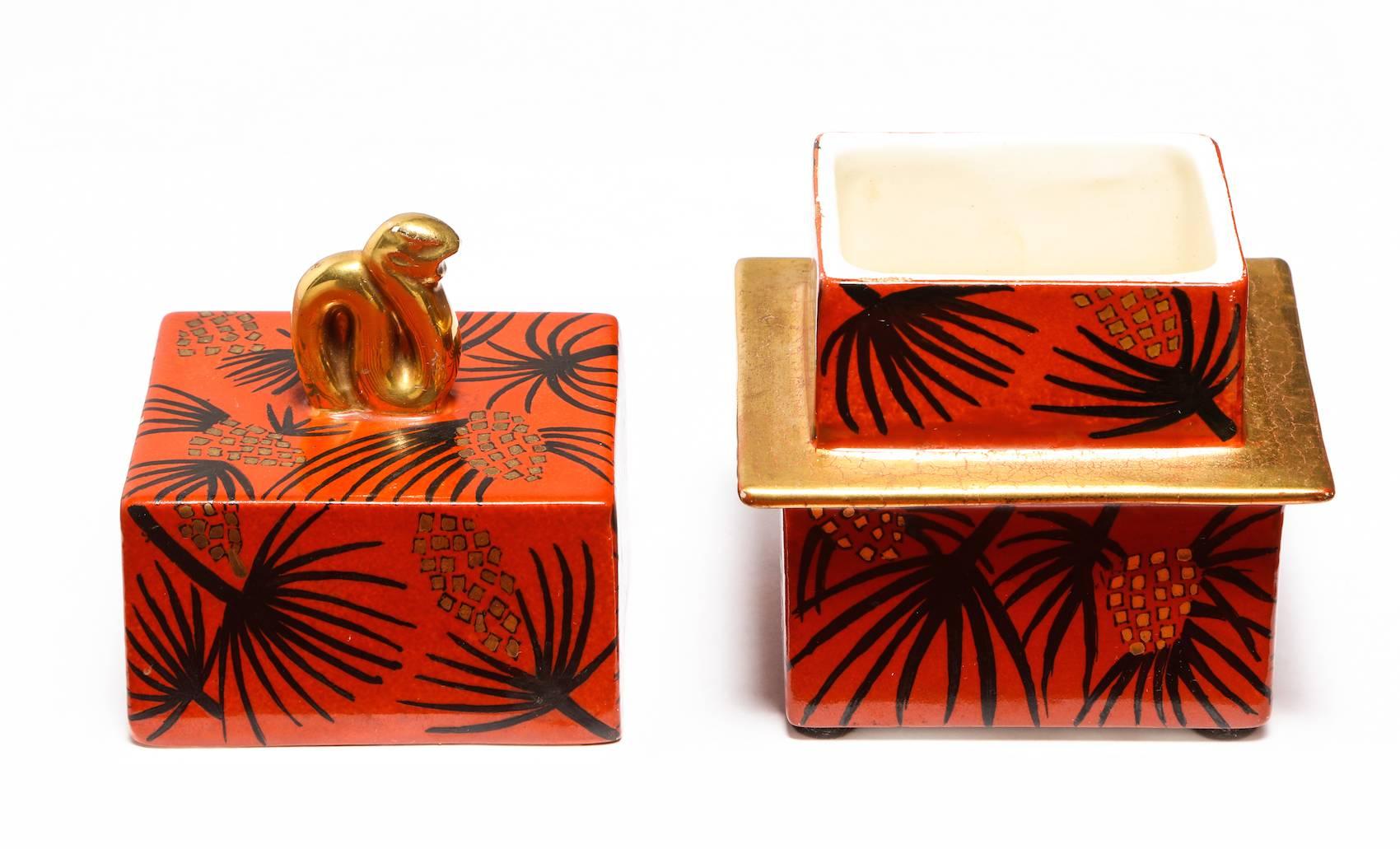 Lidded box by Gio Ponti for Richard Ginori. Square-shaped porcelain box with lid. Glazed in red and black with palm frond motif. Signed and dated on underside. Publication: Gio Ponti: alla manifattura di Doccia, pg. 69 & 99 for illustrations and