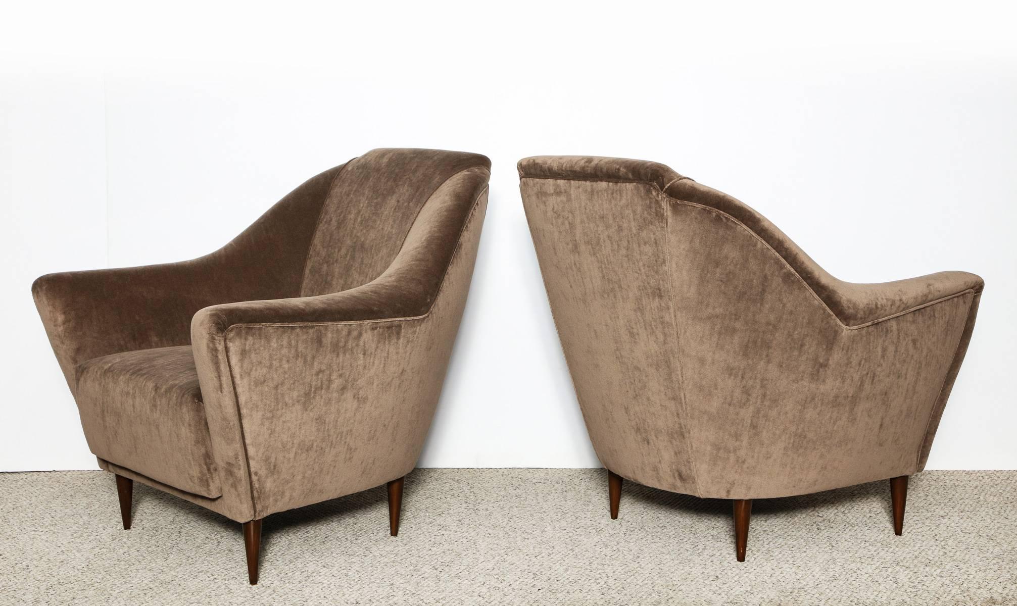 Rare pair of lounge chairs by Ico Parisi. Great lounge chairs, fully upholstered with deep seats and dark stained wood legs. Most likely produced by Ariberto Colombo, Cantù, Italy.