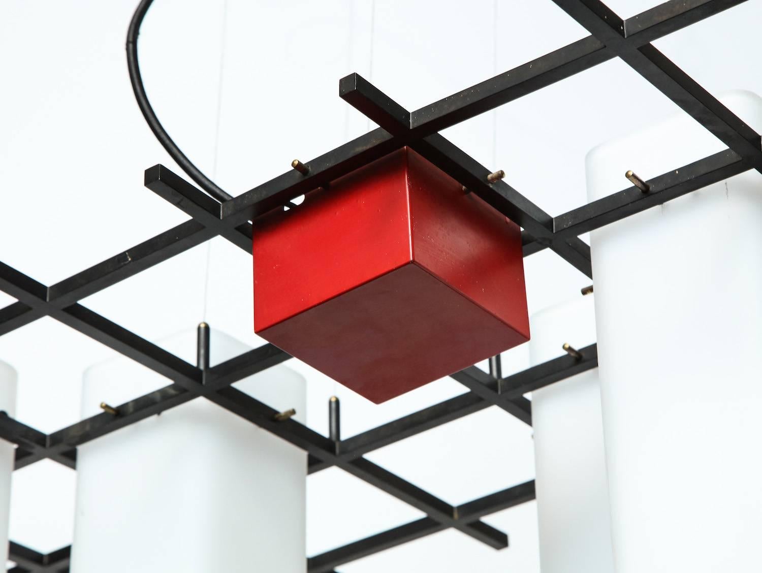 Rare hanging light #212 by Angelo Lelii for Arredoluce. Rare five-light fixture with black painted metal, red lacquered cube and frosted glass tubes that serve as light diffusers. Five standard Edison sockets. All sockets, wiring and glass elements