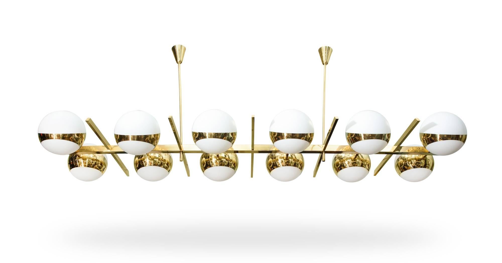 Monumental twelve-light chandelier by Fedele Papagni.
Large-scale hanging light of polished brass with frosted-glass globes. Twelve standard Edison sockets and new wiring. Made exclusively for Donzella.