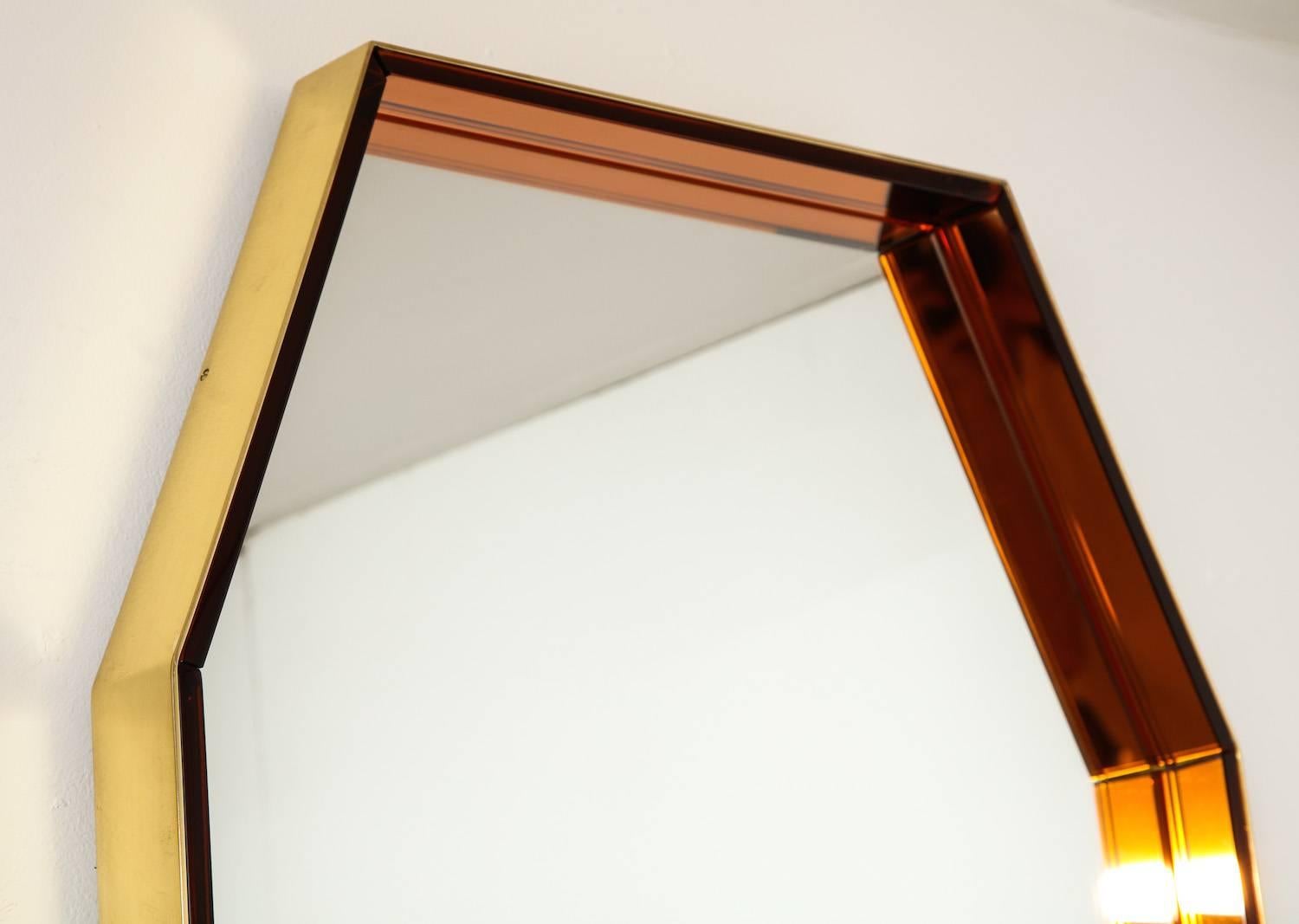 Octagonal wall mirror #2355 by Fontana Arte. Solid brass frame with brushed finish. Frame interior lined with copper colored glass. This rare form can be hung vertically or horizontally. A pair is shown here, but they are being offered individually,