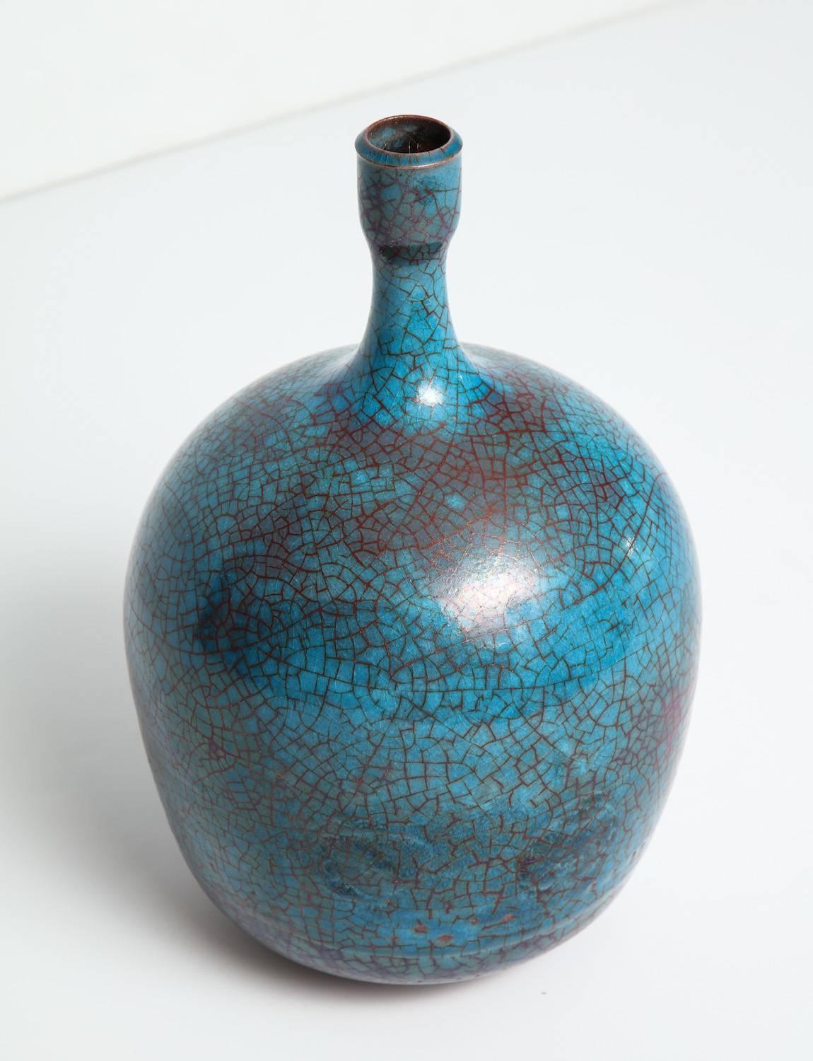 Studio built ceramic bottle by Carlo Zauli.
Large bottle form with bulbous body. Glazed in shades of turquoise and deep-blue with copper crackle running throughout. Artist-signed on underside.