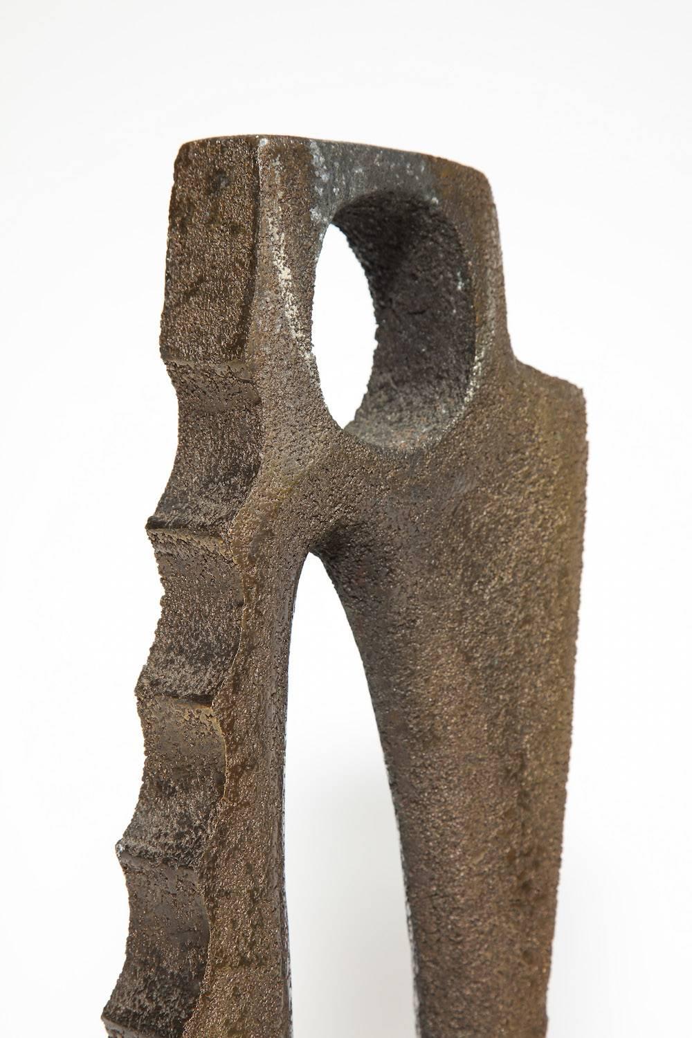 Cast bronze form with polished, rough-hewn surfaces. Beautifully realized, abstract form. Reminiscent of the work of Barbara Hepworth.
