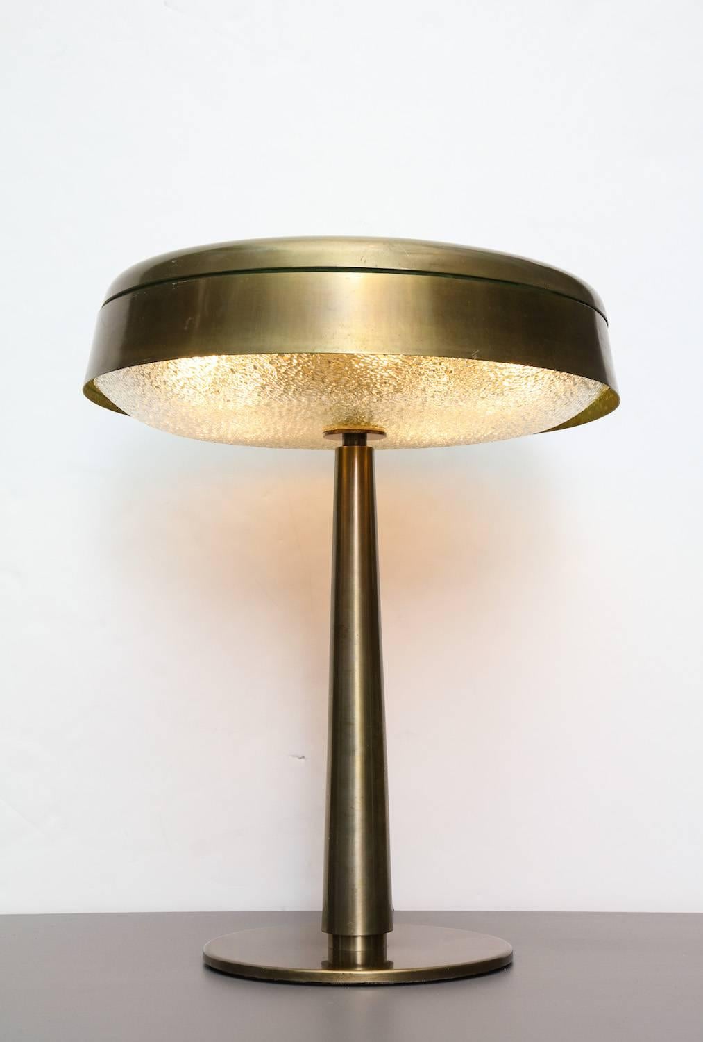 Rare table lamp, model #2278 by Fontana Arte.
Oxidized steel and brass, painted interior shade. Textured and curved glass reflector. Five candelabra sockets. Very good original condition with new sockets, wiring and plug. Original push-switch on