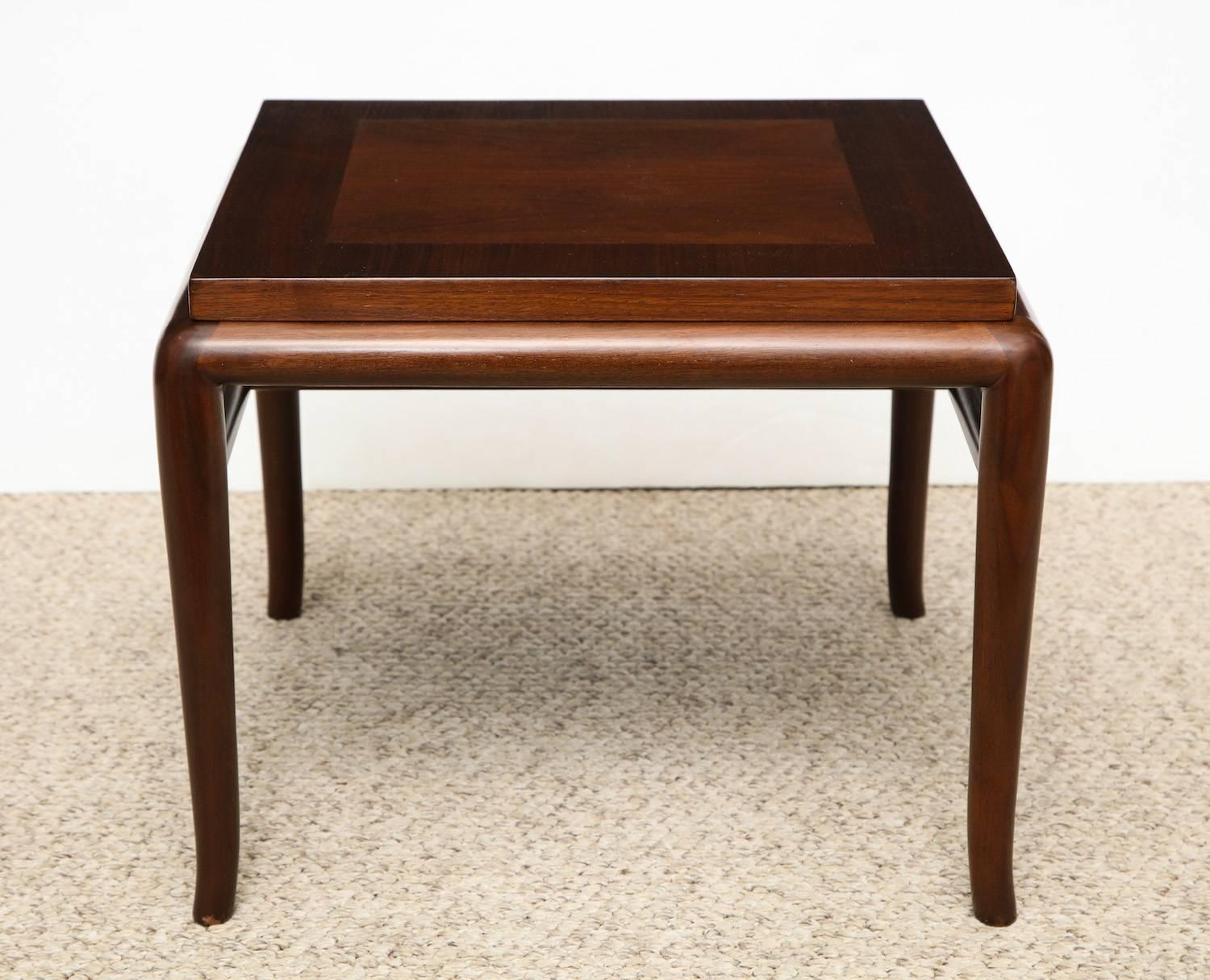 T.H Robsjohn-Gibbings side table #3361.
Elegant low table of walnut and mahogany with tapered cabriole legs. Interesting play between squared corners and rounded edges. Signed on underside and produced by Widdicomb.