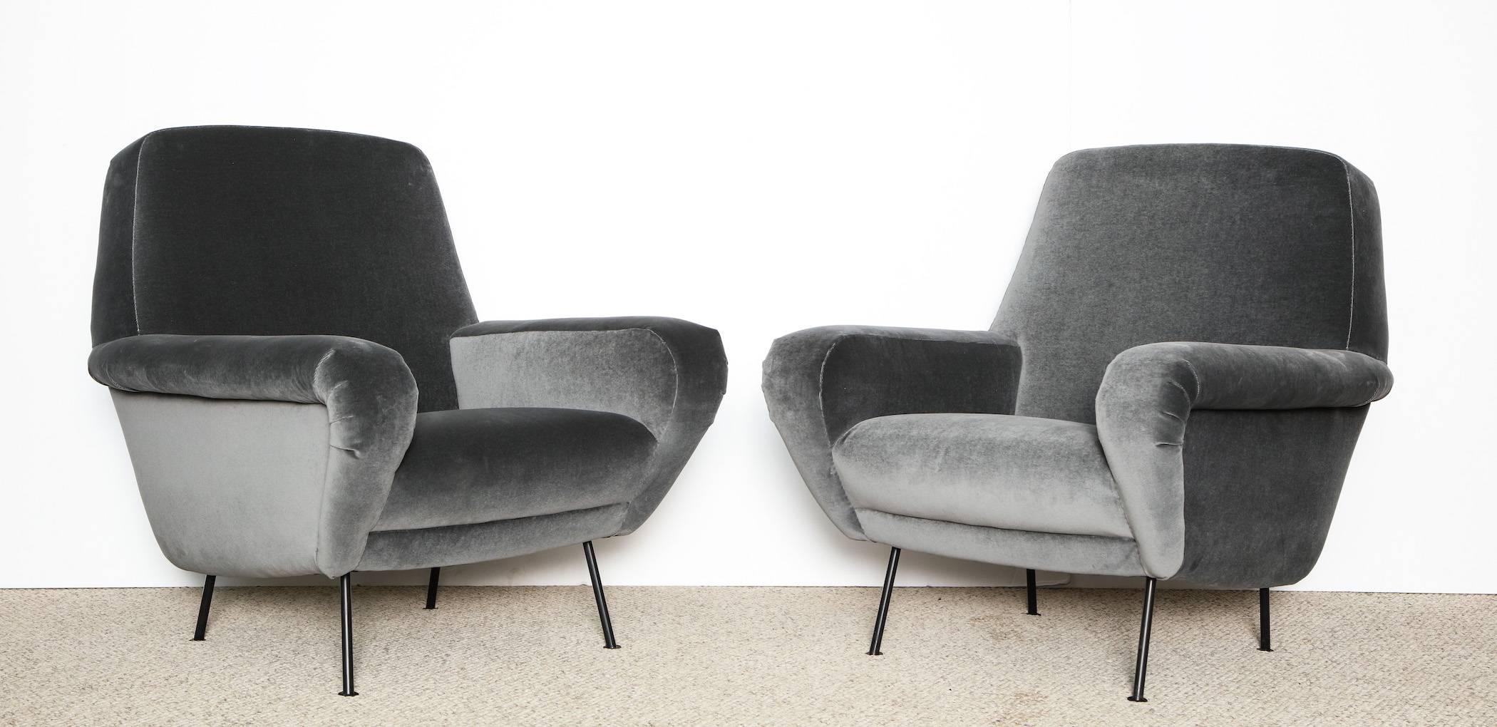 Rare pair of #830 armchairs by Gianfranco Frattini.
Upholstered armchairs with wide arms and black painted metal legs. Produced by Cassina, and recently reupholstered in gray velvet.