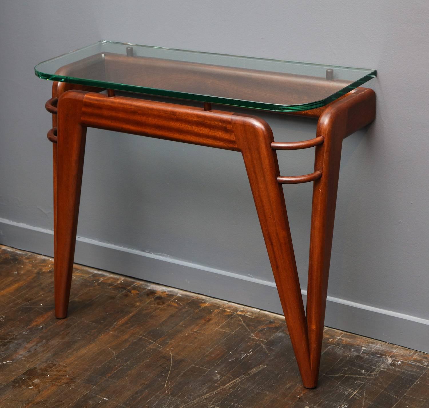 Custom design wall console.
Studio-built mahogany console table that secures itself to the wall. Thick floating glass top with rounded corners. Can be made in custom sizes. 12-15 week lead time.